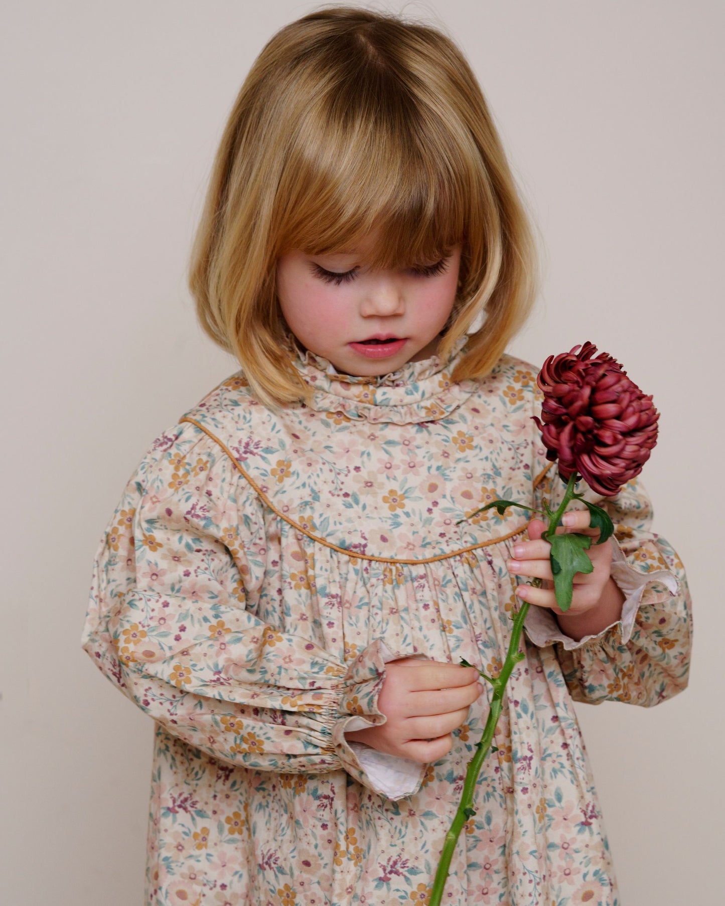 Early Sunday, Penelope Dress in Floral print, made from Printed Cotton Satin fabric, featuring Hand-embroidered floral motifs, shown in a close up shot of model wearing it