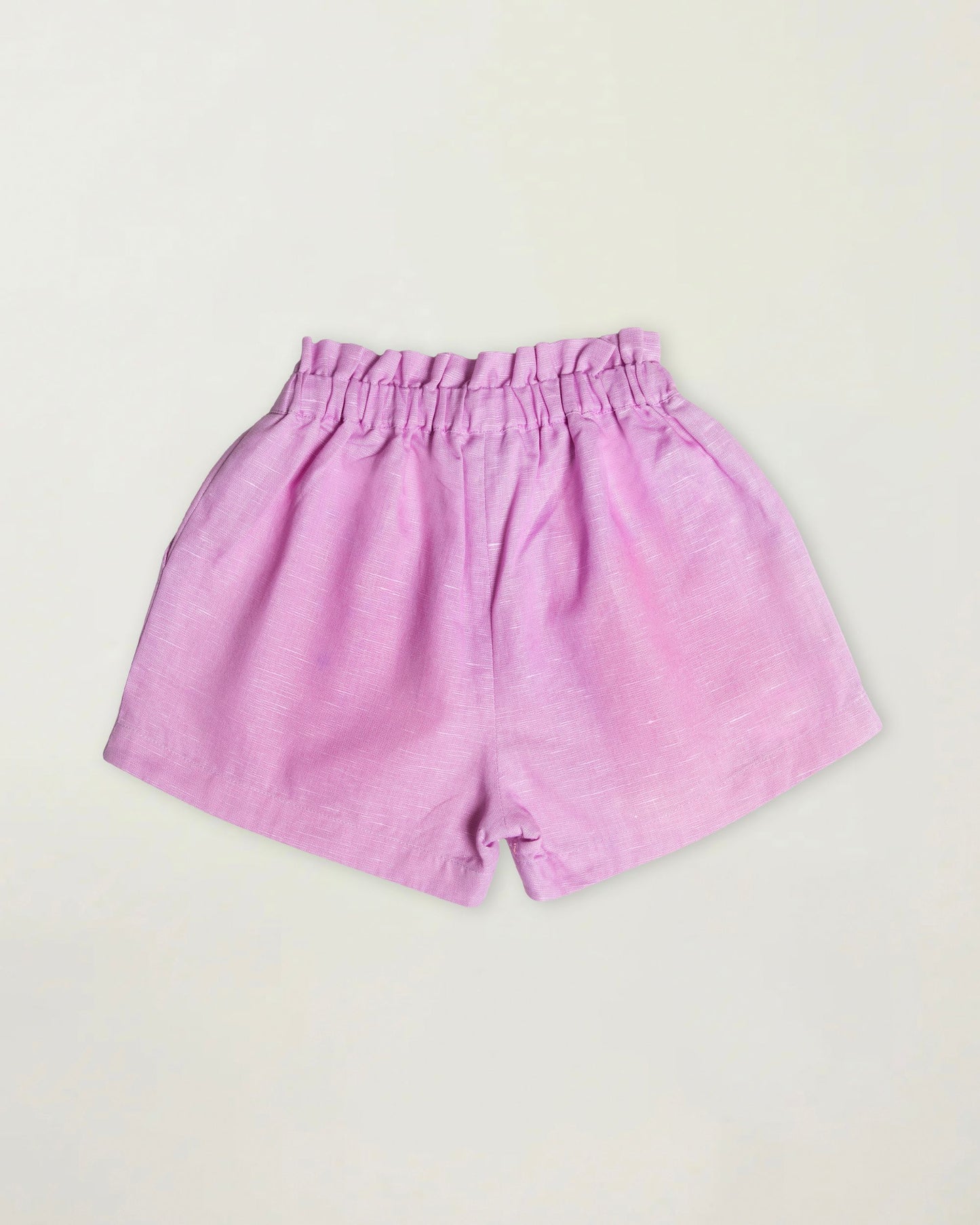 Early Sunday, Roman Short in Lilac color, made from 70% Cotton 30% Linen fabric, featuring a relaxed fit with an elastic waistband & beautiful embroidery, shown in a back flat-lay view