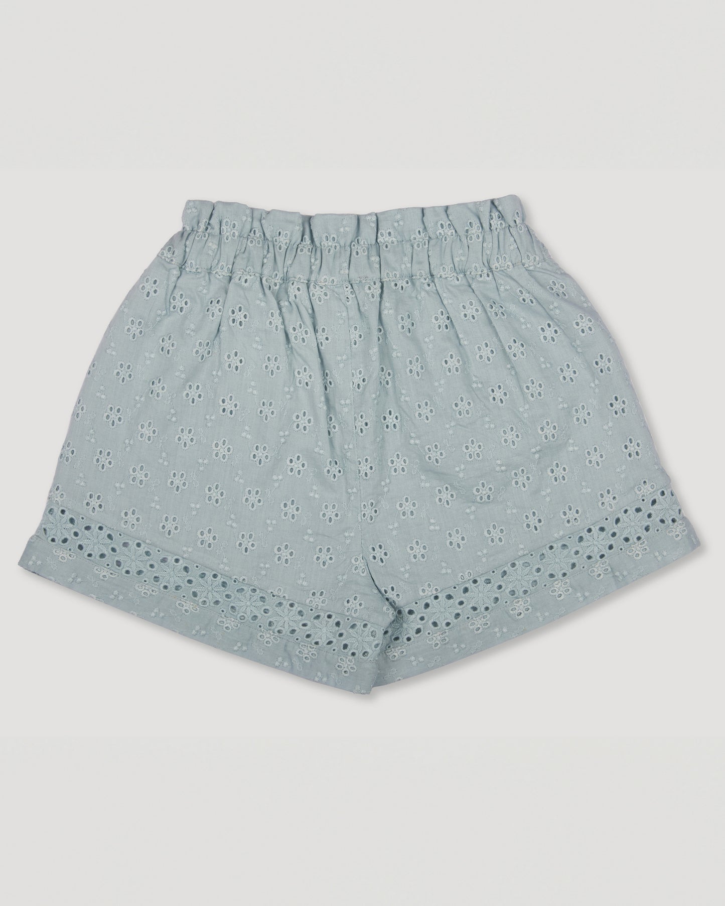 Early Sunday, Roman Shorts in Sea Dream color, made from All-Over Eyelet Embroidered Cotton Schifflie fabric, featuring relaxed fit with delicate finishes, combining style and functionality, shown in a back flat-lay view