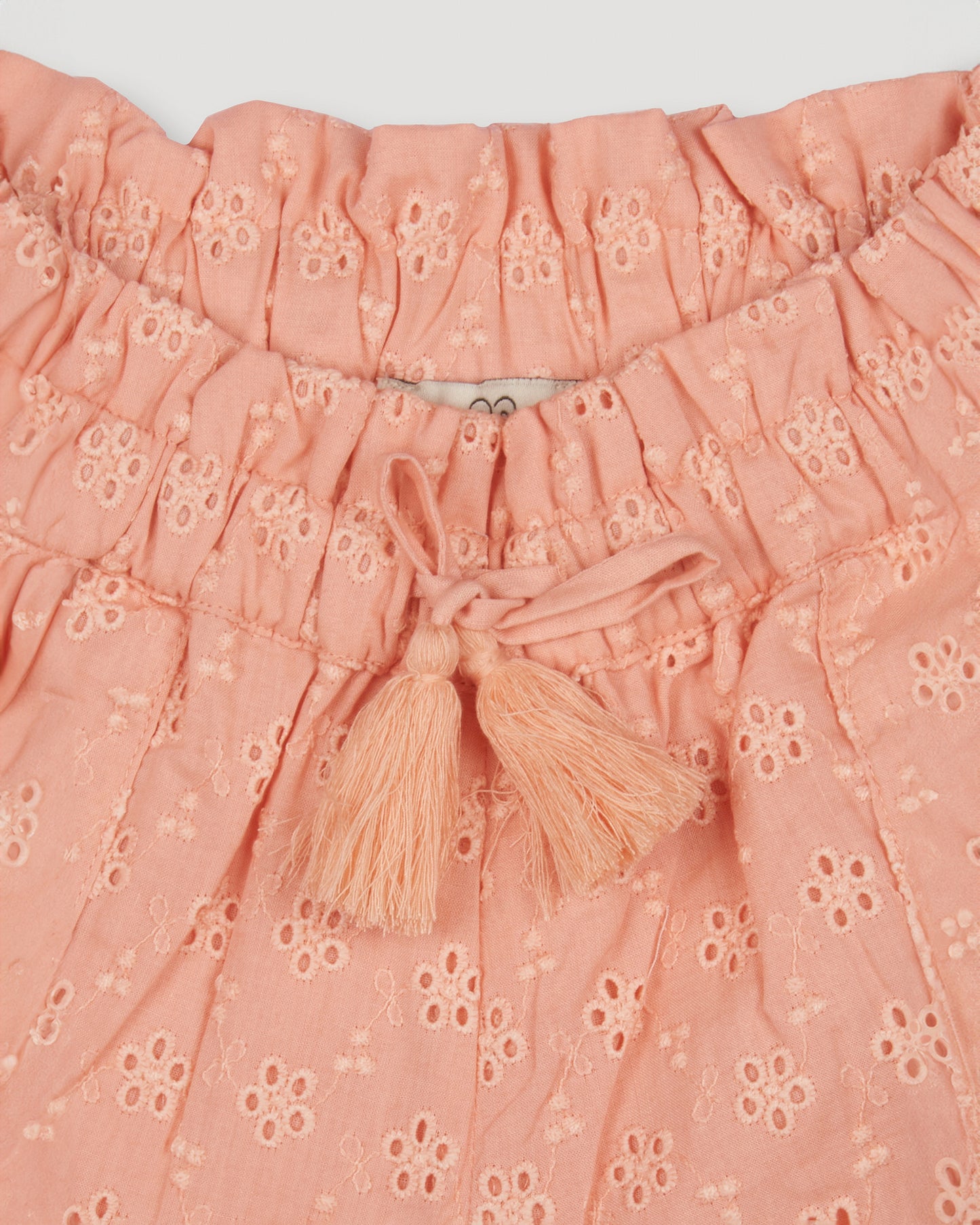 Early Sunday, Roman Shorts in Strawberry color, made from All-Over Eyelet Embroidered Cotton Schifflie fabric, featuring relaxed fit with delicate finishes, combining style and functionality, shown in a closeup flat-lay view