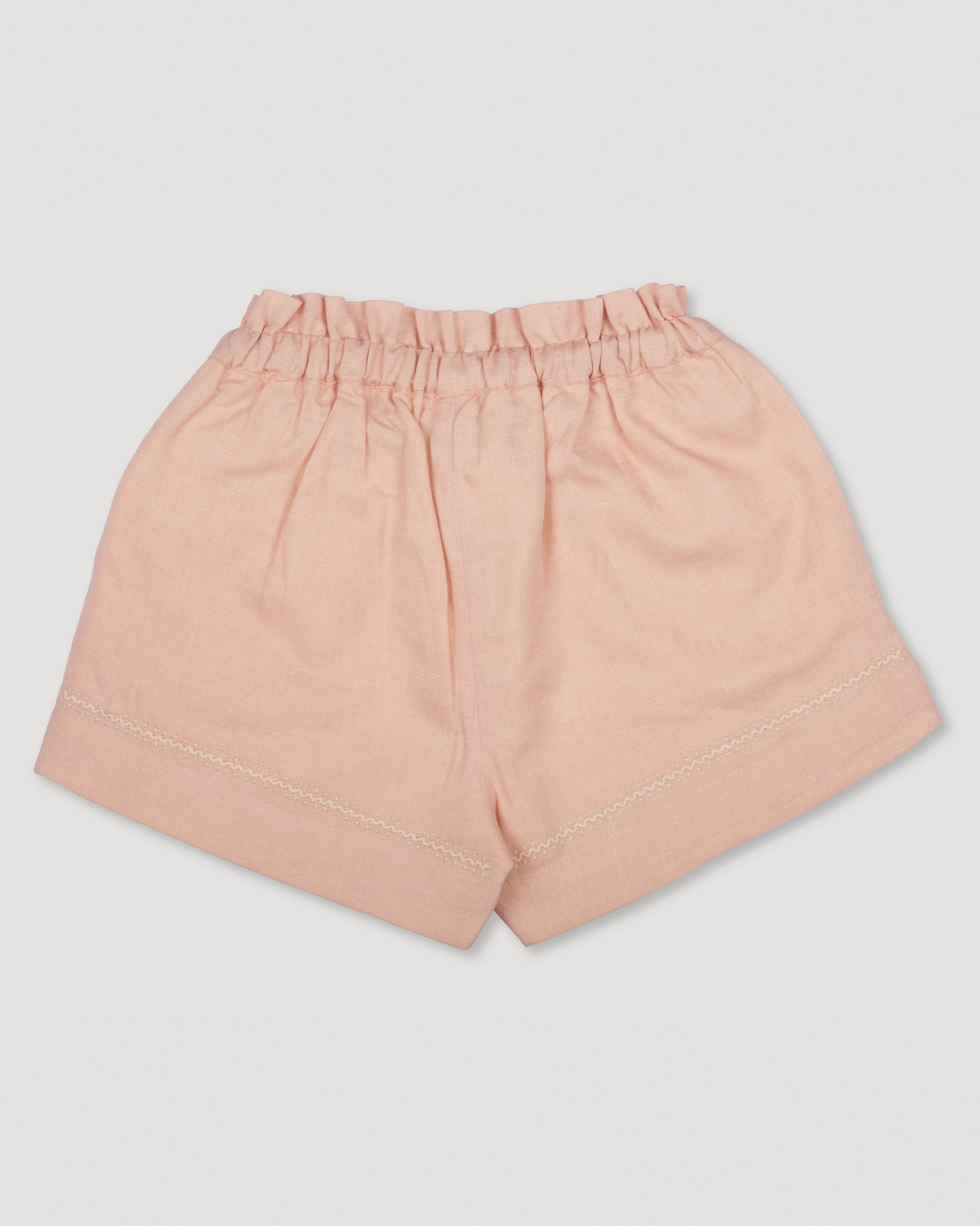 Early Sunday, Roman Shorts in Pink Sand color, made from Canvas 70% Cotton 30% Linen fabric, featuring relaxed fit with delicate finishes, combining style and functionality, shown in a back flat-lay view