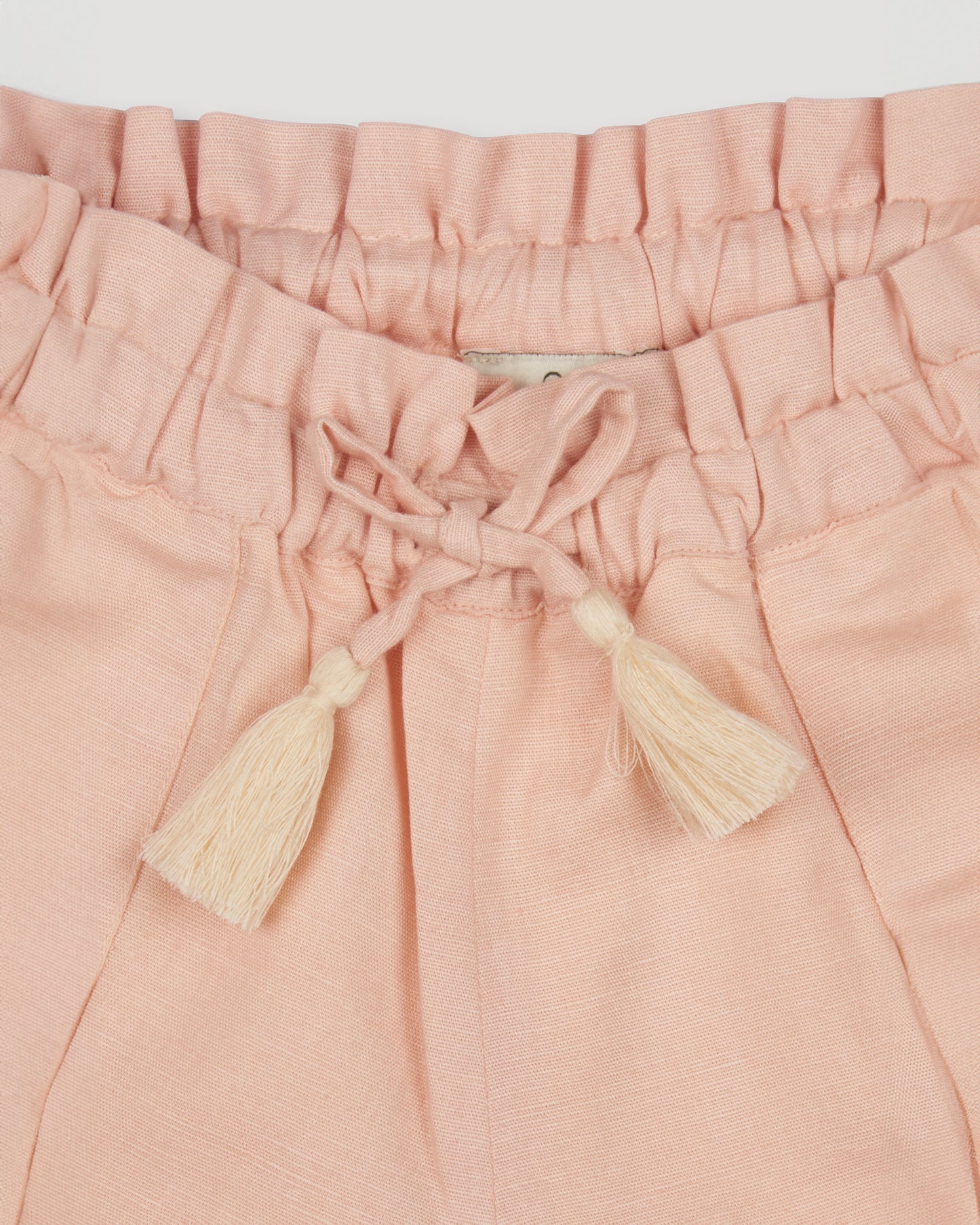 Early Sunday, Roman Shorts in Pink Sand color, made from Canvas 70% Cotton 30% Linen fabric, featuring relaxed fit with delicate finishes, combining style and functionality, shown in a closeup flat-lay view