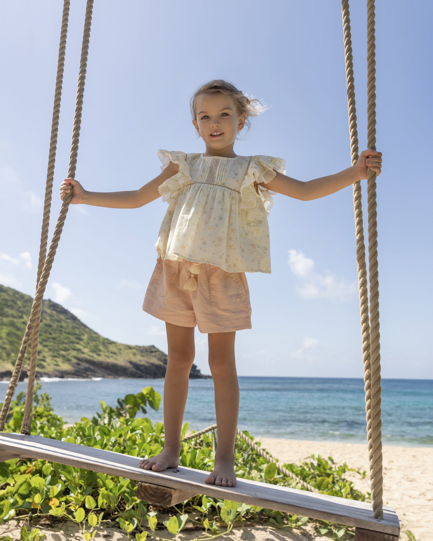 Early Sunday, Roman Shorts in Pink Sand color, made from Canvas 70% Cotton 30% Linen fabric, featuring relaxed fit with delicate finishes, combining style and functionality, shown in a front view of model wearing it