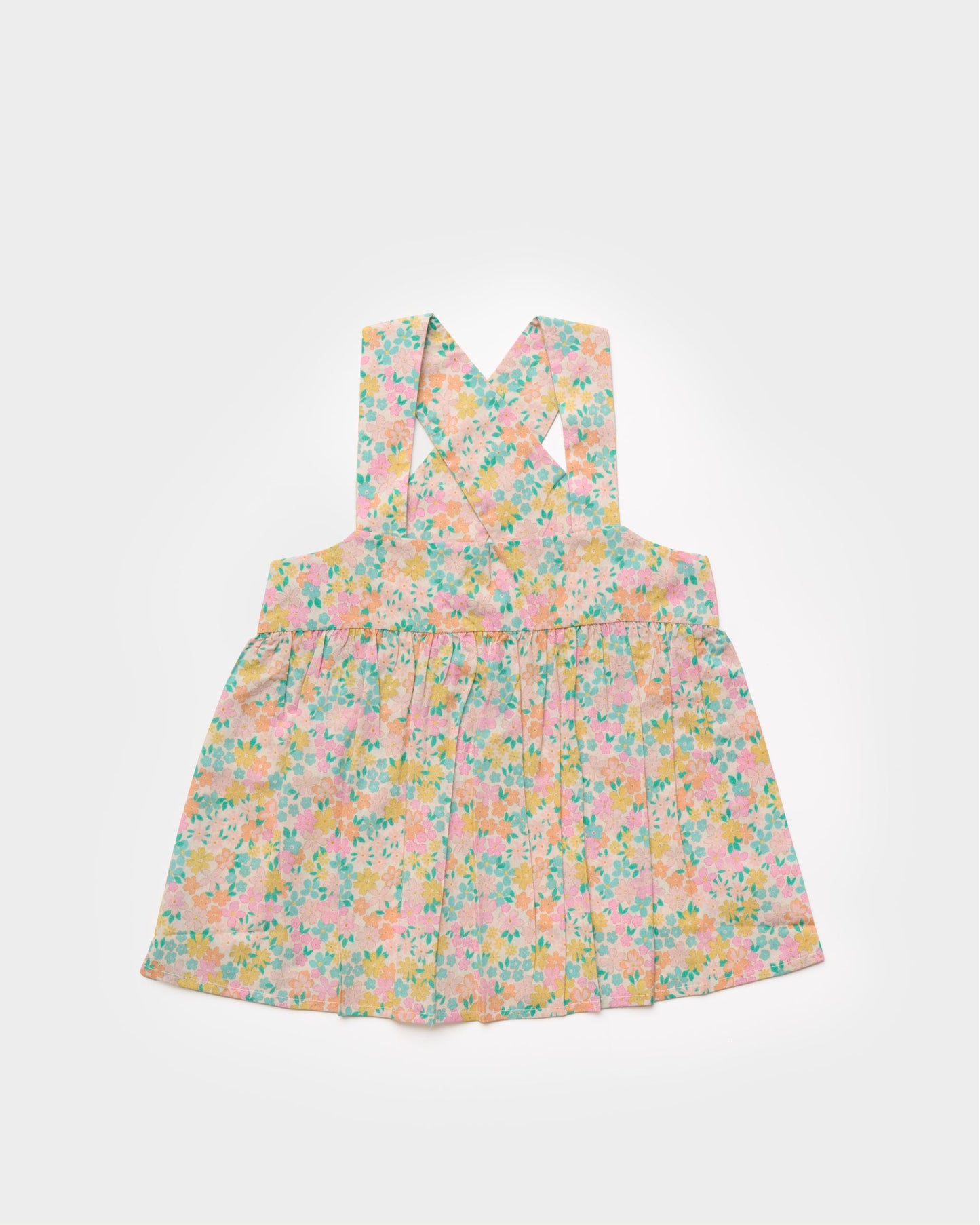 Early Sunday, Romy Blouse in Emma Floral Mint color, made from Organic Printed 60s Cotton Cambric fabric, featuring a sleeveless design with cross-back straps, a gathered waist & a soft flared silhouette, shown in a front flat-lay view