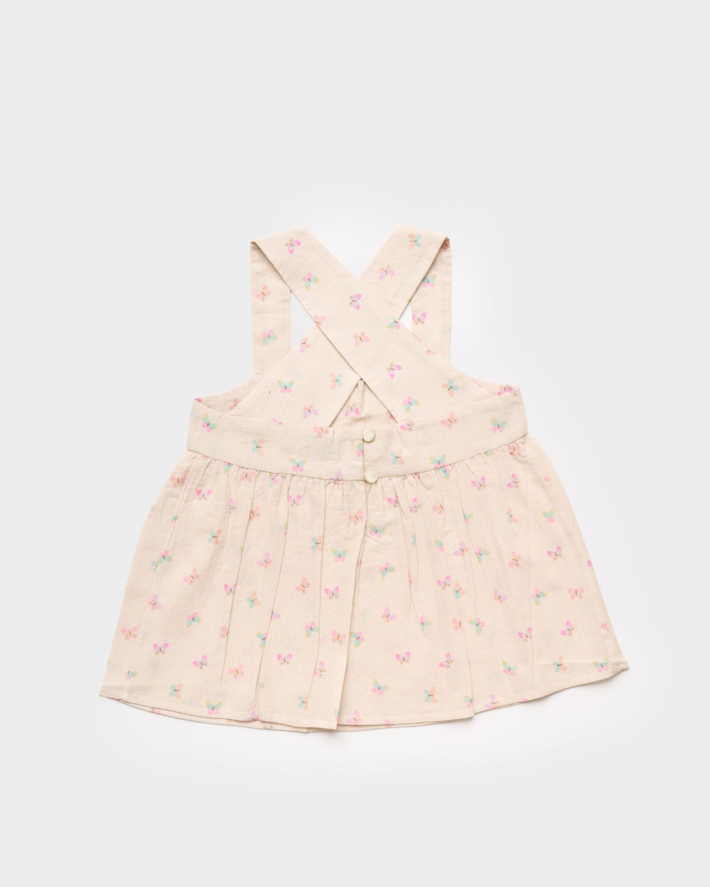 Early Sunday, Romy Blouse in Butterflies print, made from Printed Cotton Tiny Swiss Dobby fabric, featuring a sleeveless design with cross-back straps, a gathered waist & a soft flared silhouette, shown in back flat-lay view