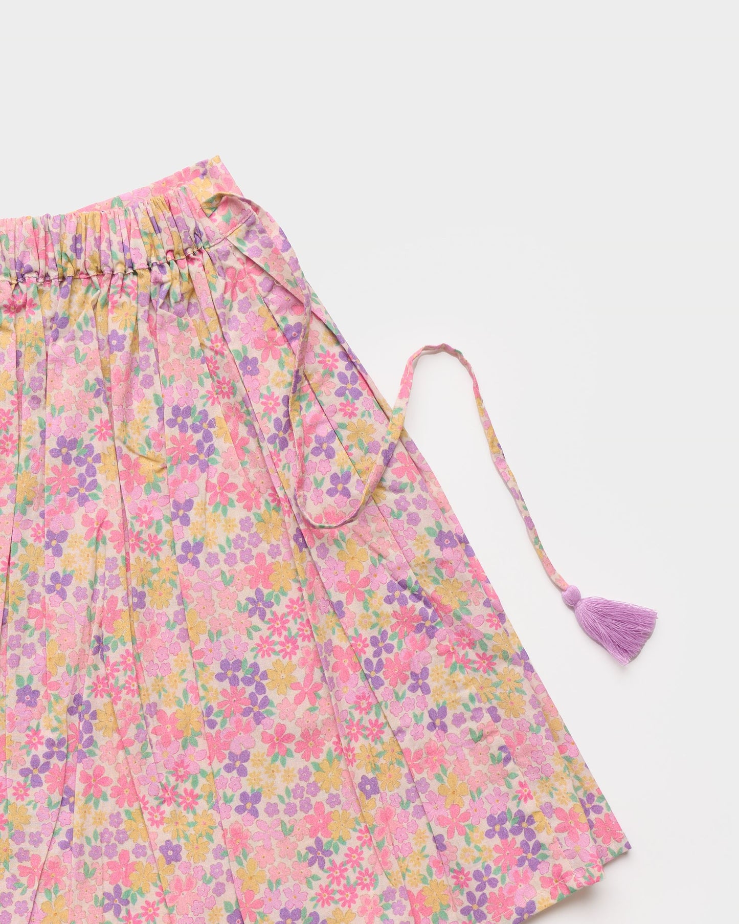 Early Sunday, Ruth Skirt in Emma Floral Purple color, made from Organic Printed Cotton Cambric fabric, featuring a flared silhouette with an elastic waistband & floral design, shown in a closeup flat-lay view
