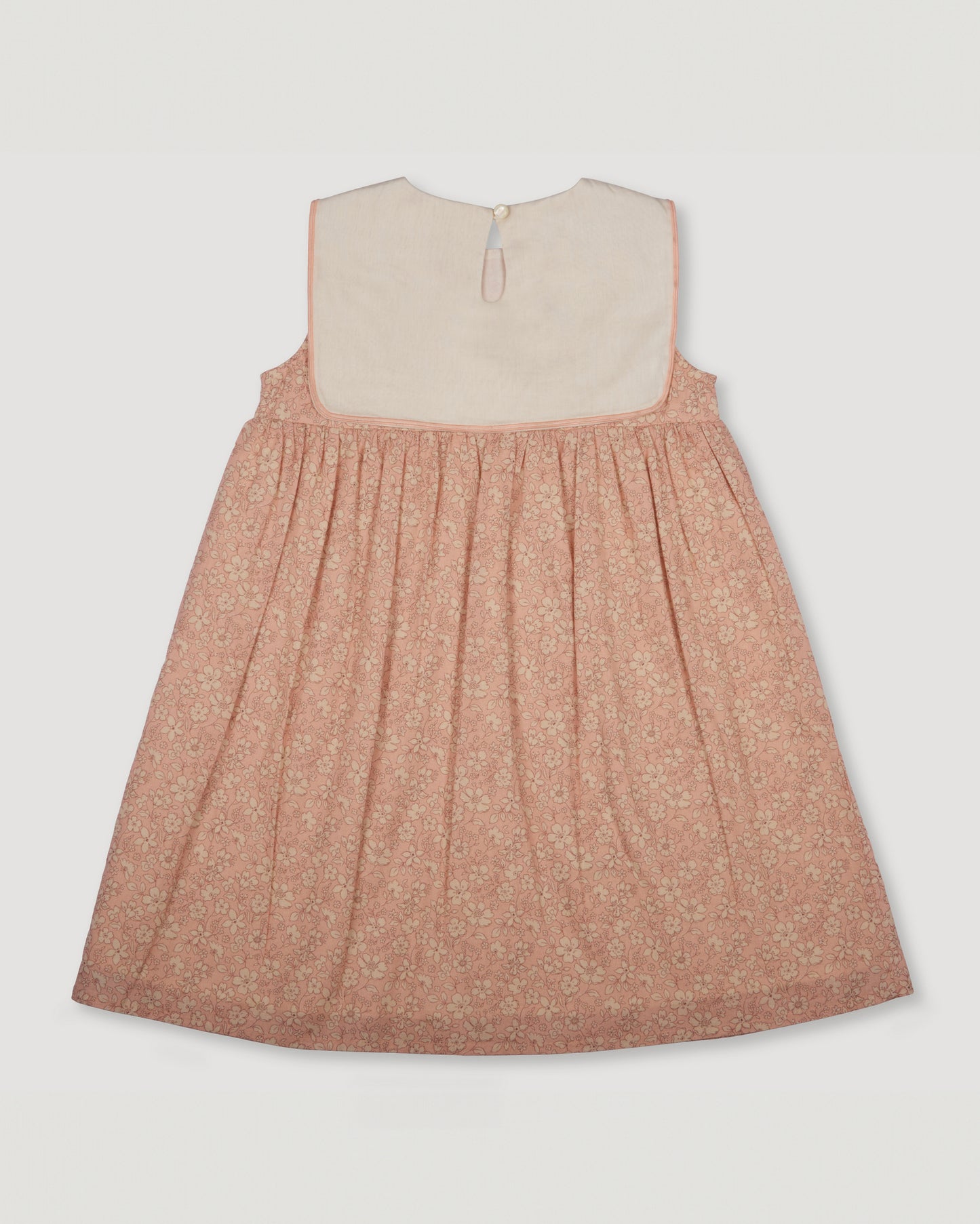 Early Sunday, Sabrina Dress in Garden Flowers print, made from Printed Cotton Cambric fabric, featuring flattering fit with delicate finishes, combining style and functionality for an effortlessly elegant look, shown in a back flat-lay view