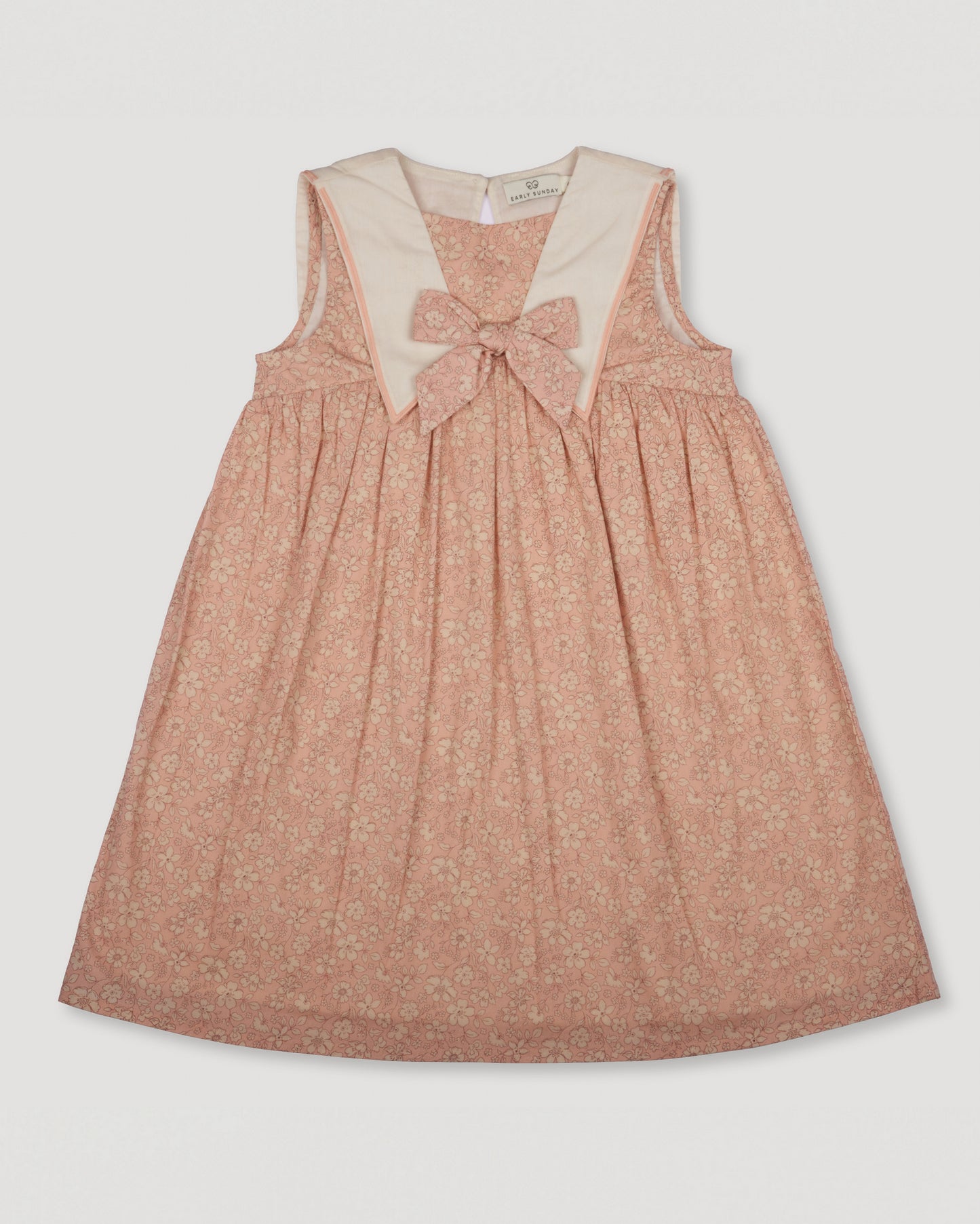 Early Sunday, Sabrina Dress in Garden Flowers print, made from Printed Cotton Cambric fabric, featuring flattering fit with delicate finishes, combining style and functionality for an effortlessly elegant look, shown in a front flat-lay view