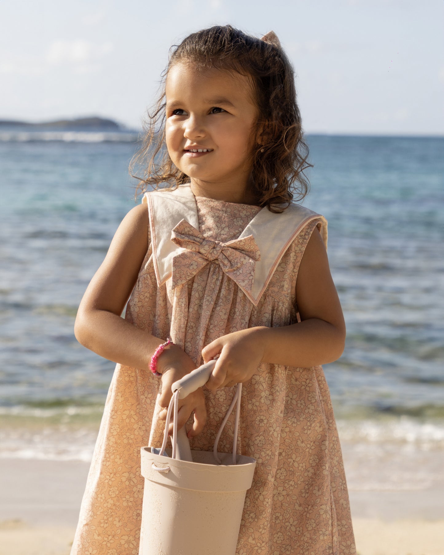 Early Sunday, Sabrina Dress in Garden Flowers print, made from Printed Cotton Cambric fabric, featuring flattering fit with delicate finishes, combining style and functionality for an effortlessly elegant look, shown in a front view of model wearing it