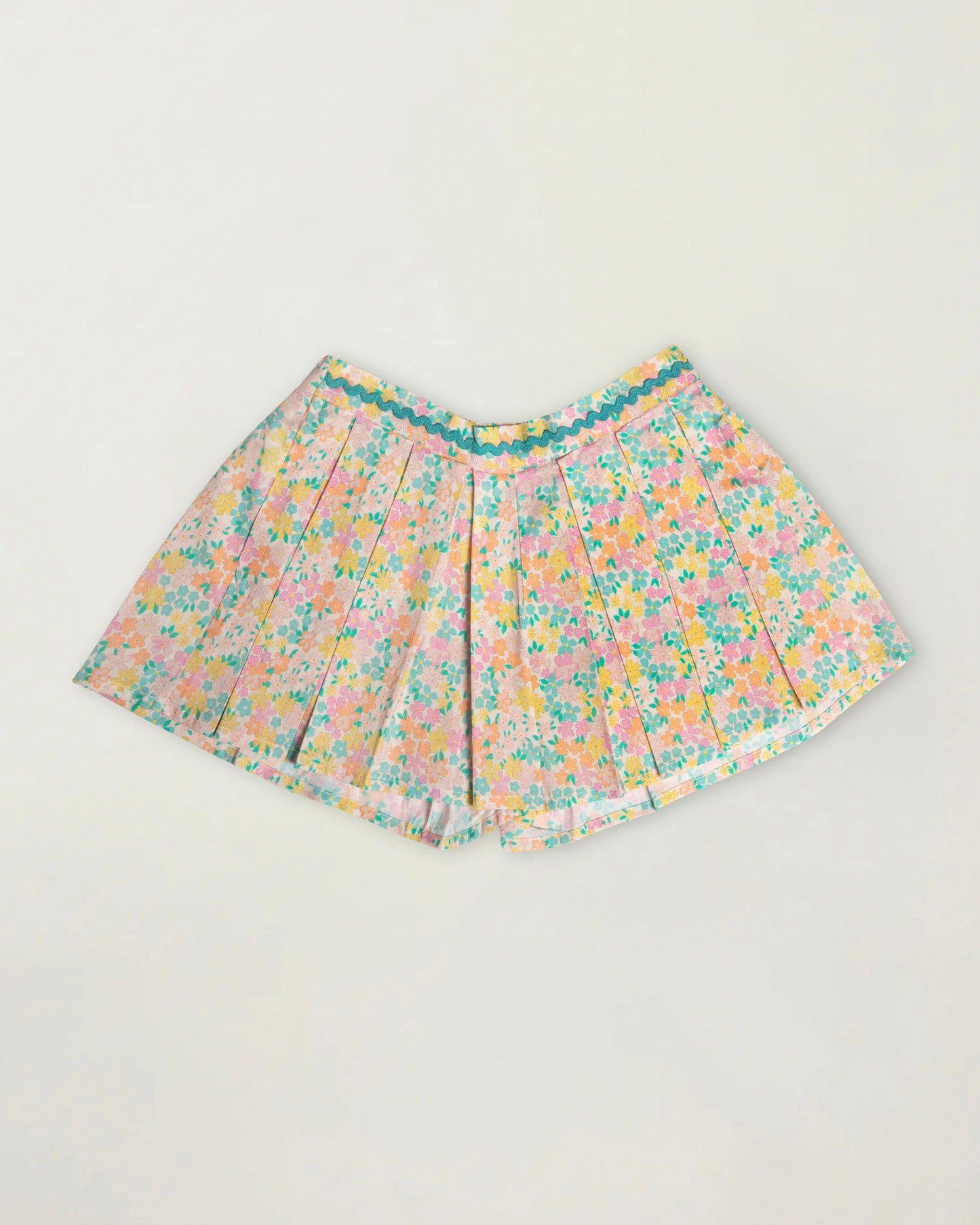 Early Sunday, Solal Skort in Emma Floral Mint color, made from Organic Printed Cotton Cambric fabric, featuring a flared skirt overlay with attached shorts & elastic waistband, shown in a front flat-lay view