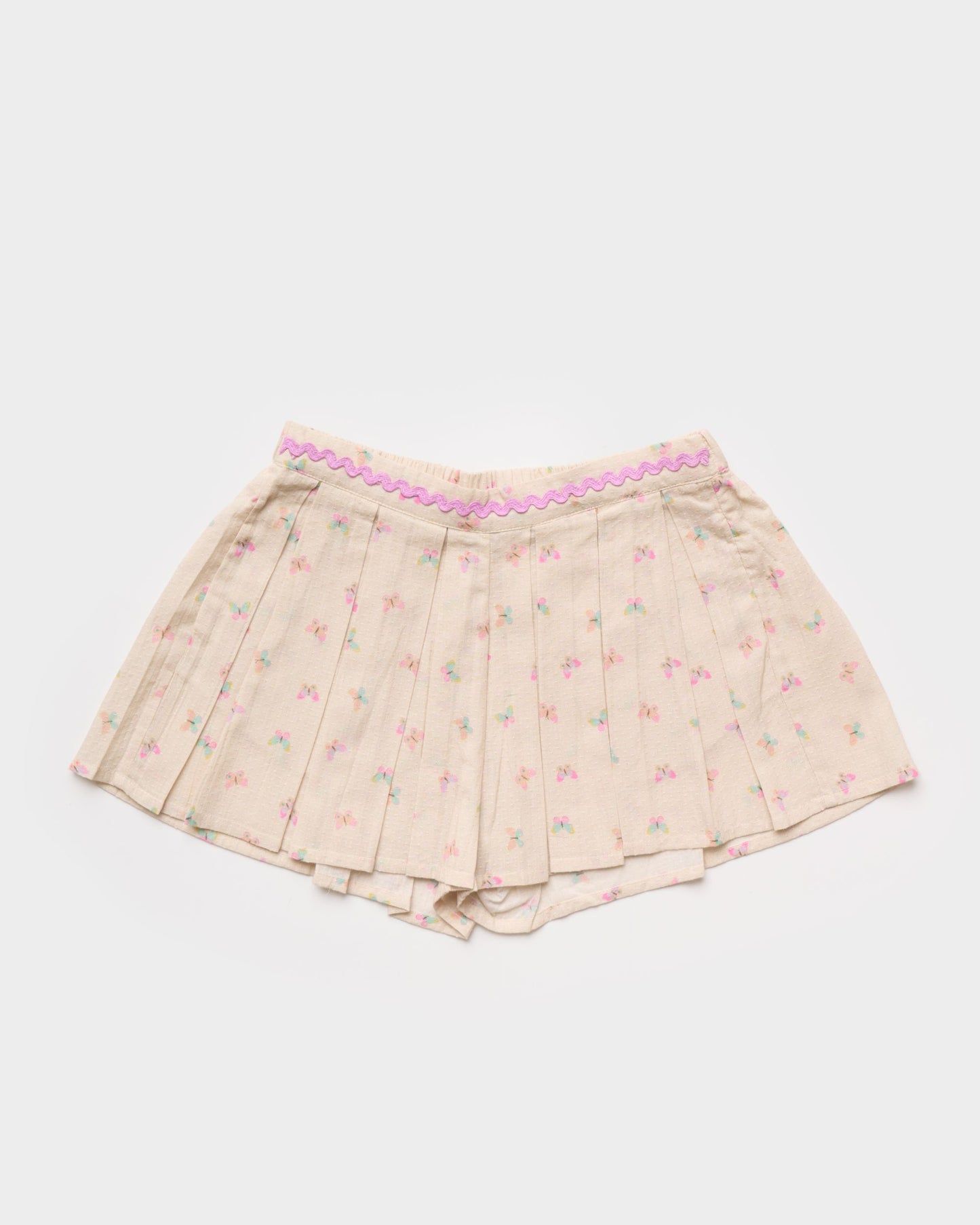 Early Sunday, Solal Skort in Butterflies print, made from Printed Cotton Tiny Swiss Dobby fabric, featuring a flared skirt overlay with attached shorts & elastic waistband, shown in a front flat-lay view