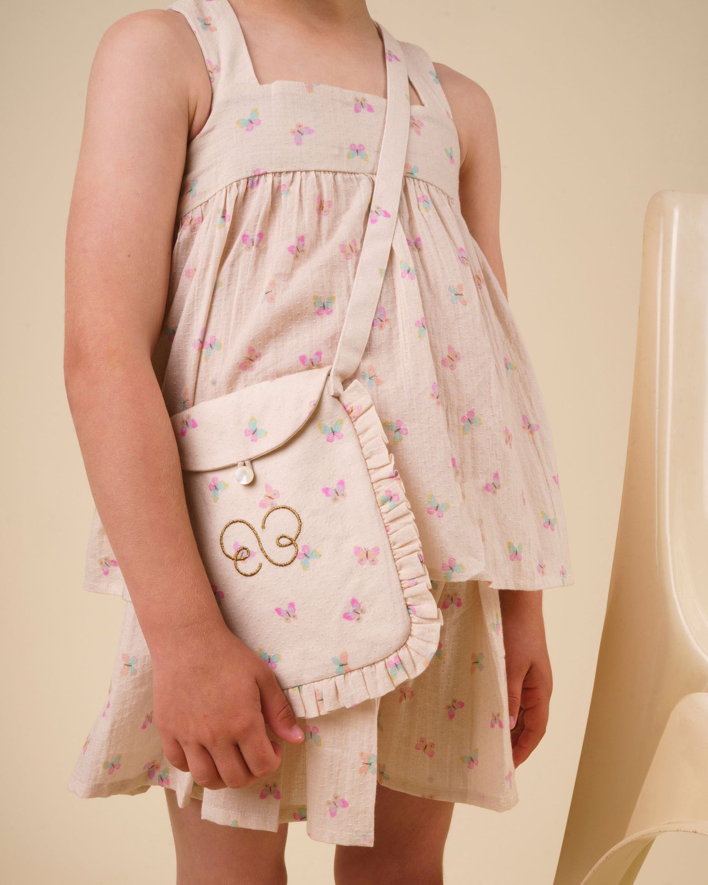Early Sunday, Solal Skort in Butterflies print, made from Printed Cotton Tiny Swiss Dobby fabric, featuring a flared skirt overlay with attached shorts & elastic waistband, shown in a close-up shot of a model wearing it during a studio shoot