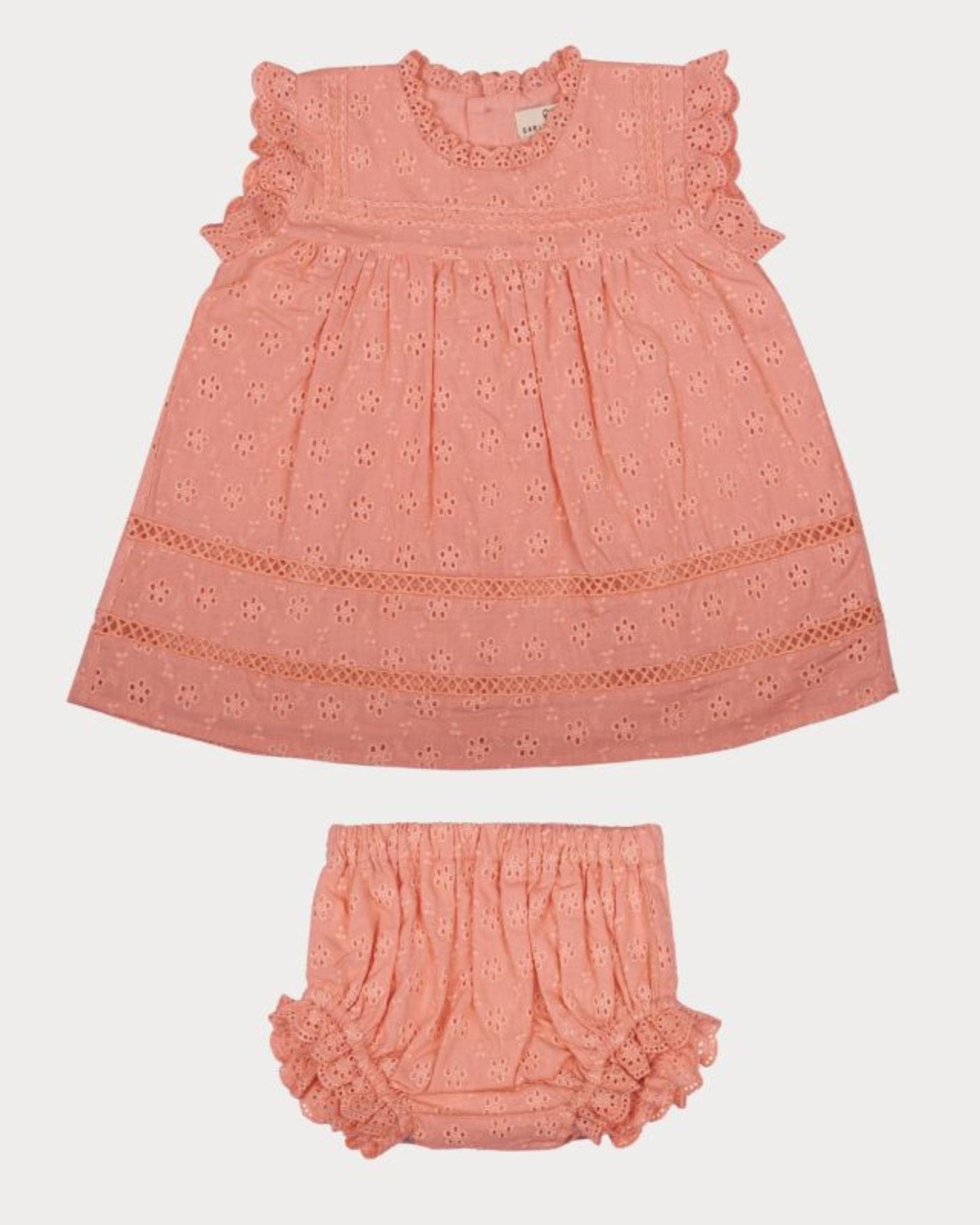 Early Sunday, Susie Baby Dress & Bloomer in Strawberry color, made from All-Over Eyelet Embroidered Cotton Schifflie fabric, featuring flared dress with a relaxed fit for ease of movement, matching bloomer with an elasticated waistband for comfort and flexibility, shown in a front flat-lay view