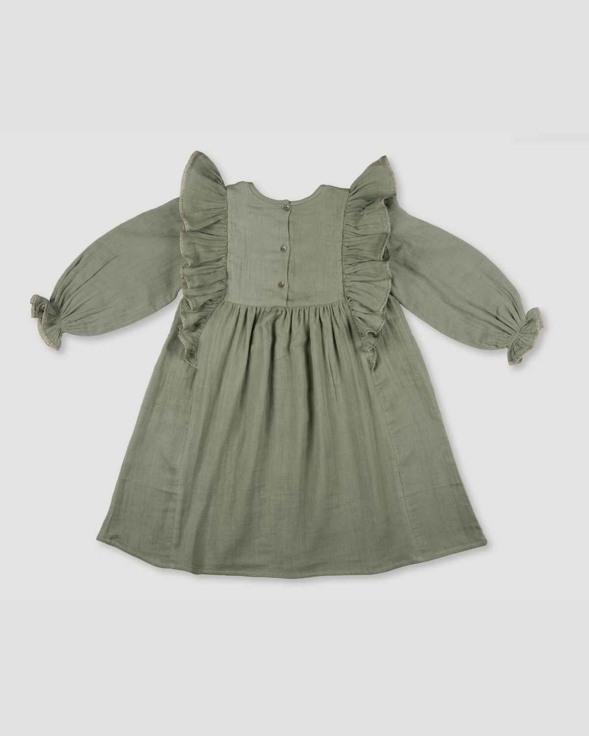 Early Sunday, Suzanne Dress in Halcyon Green, made from Cotton Double Gauze fabric, featuring classic silhouette with floral embroidery around the yoke and ruffle detailing, shown in a back flat-lay view