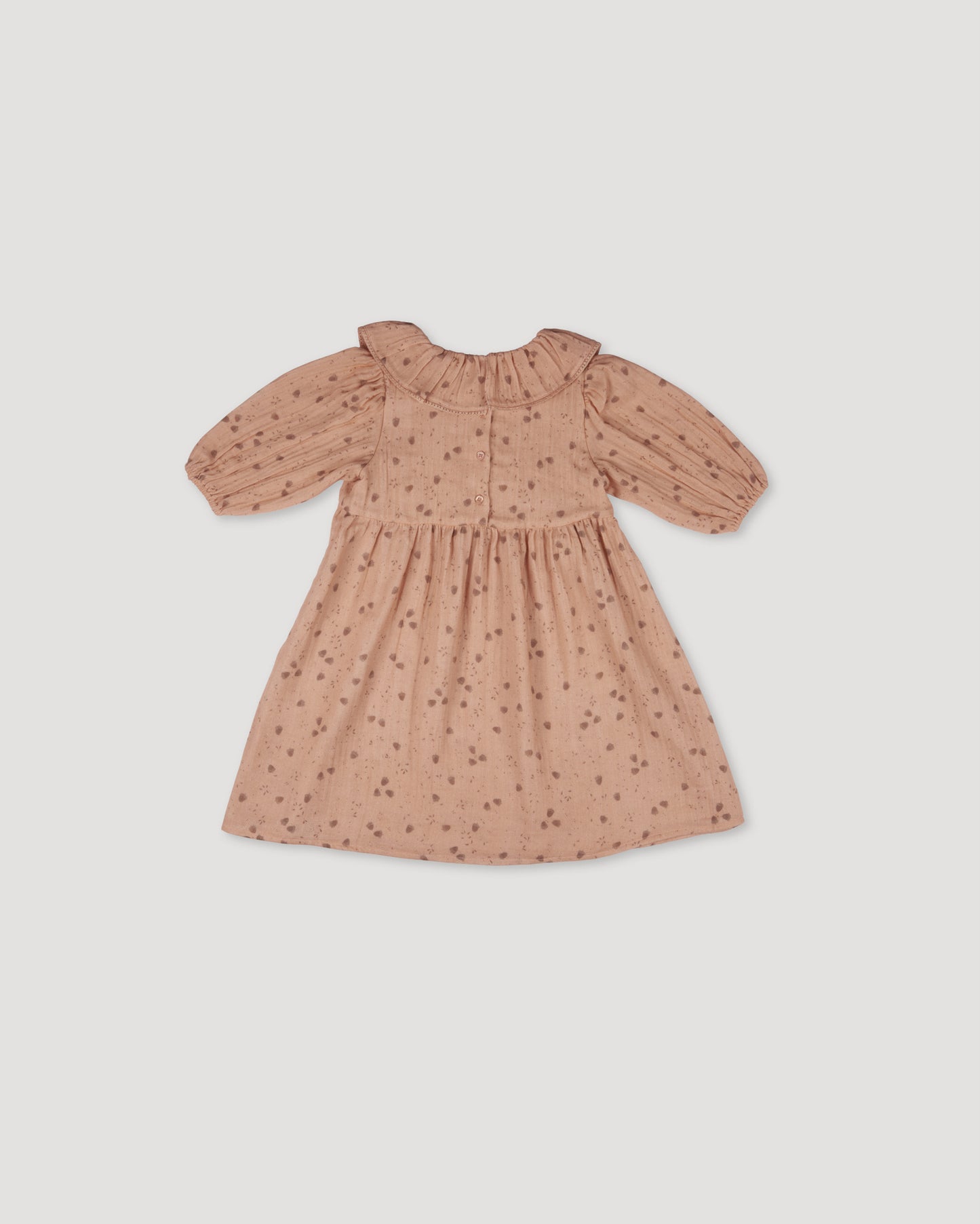 Early Sunday, Suzie Dress in Acorn Dusty Pink, made from Printed Cotton Double Gauze fabric, featuring classic silhouette with a ruffle neckline and mother-of-pearl buttons, shown in a back flat-lay view