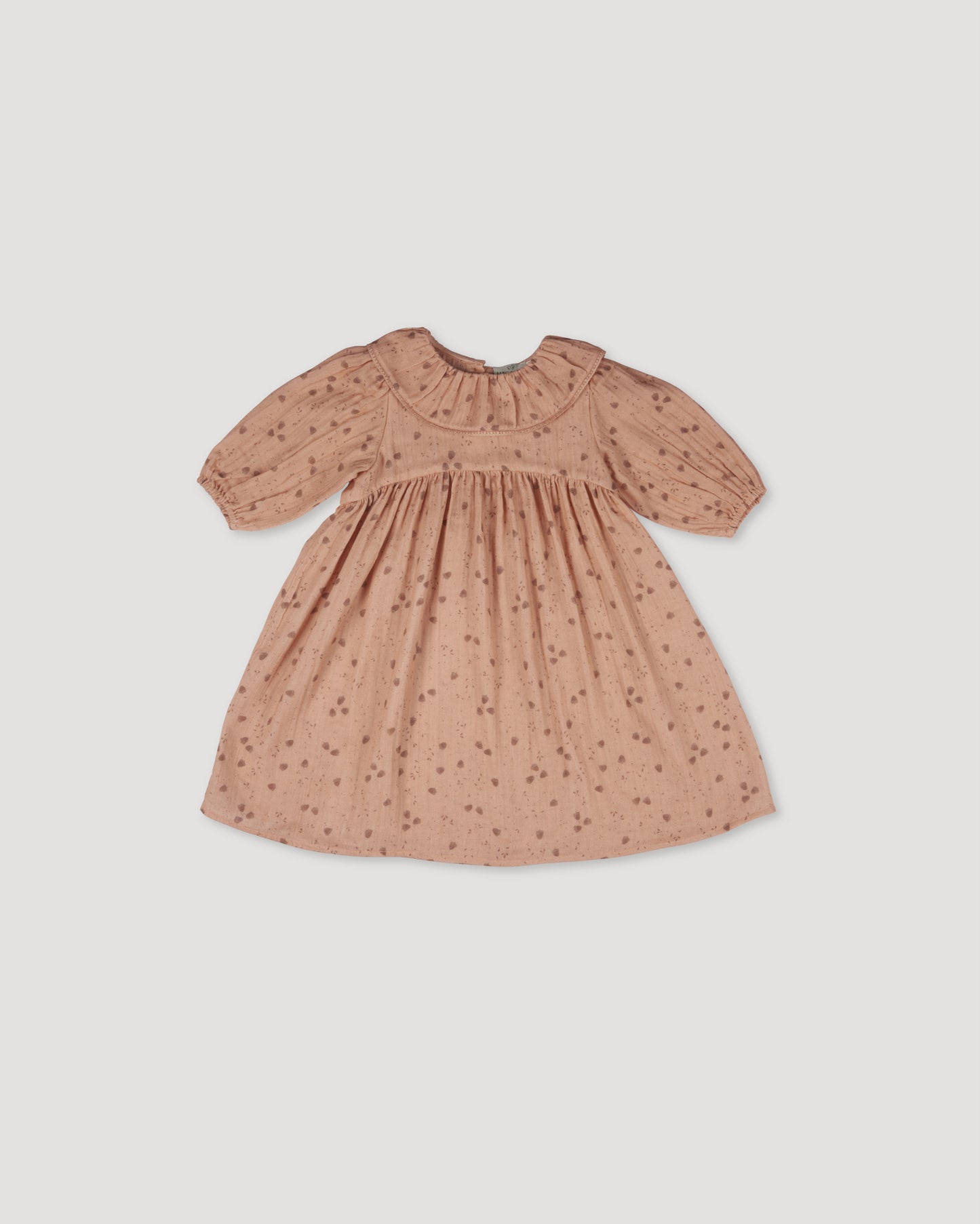 Early Sunday, Suzie Dress in Acorn Dusty Pink, made from Printed Cotton Double Gauze fabric, featuring classic silhouette with a ruffle neckline and mother-of-pearl buttons, shown in a front flat-lay view