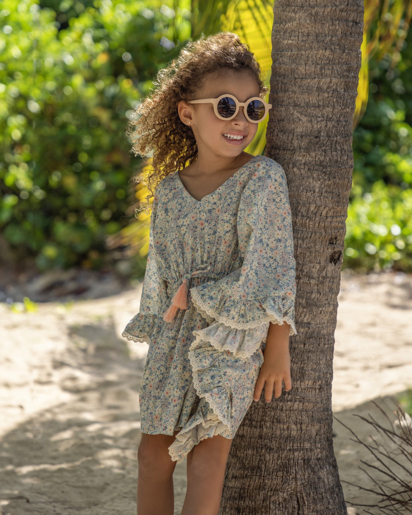 Early Sunday, Tony Kaftan in Amelia print, made from Printed Cotton Cambric fabric, featuring flowing kaftan silhouette with a gathered waist and tassel tie detail, shown in a front view of model wearing it