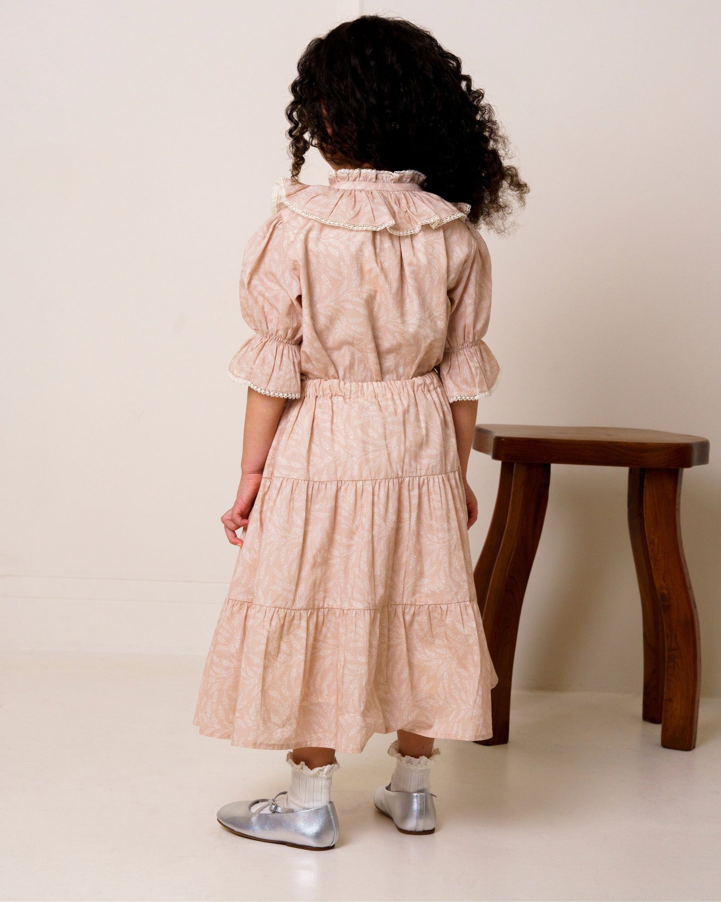 Early Sunday, Victoria Skirt in Feather print, made from Printed Cotton Cambric fabric, featuring Tiered silhouette for natural movement and volume, shown in a back view of model wearing it