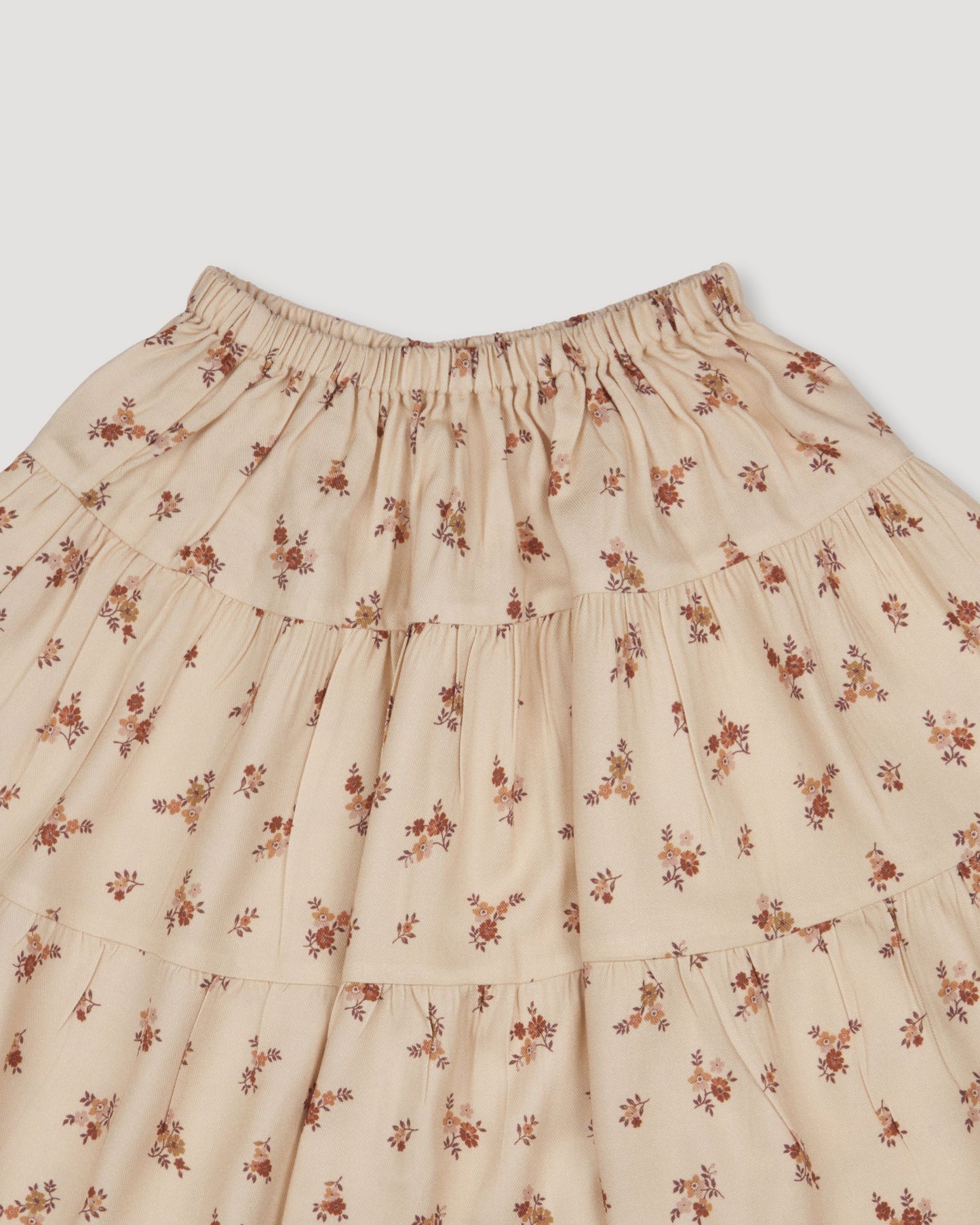 Early Sunday, Victoria Skirt in Ditsy Bouquet Cream print, made from Printed Viscose Rayon Twill fabric, featuring Tiered silhouette for natural movement and volume, shown in a closeup flat-lay view