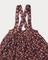 Early Sunday, Annie Skirt in Garden Flowers Plum, made from Printed Cotton Satin fabric, featuring an A-line silhouette with adjustable cross-back straps and soft gathers, shown in a closeup flat-lay view