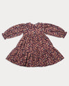 Early Sunday, Marguerite Dress in Garden Flowers Plum, made from Printed Cotton Satin fabric, featuring floral print and detailed lace yoke with Peter Pan collar, shown in a front flat-lay view
