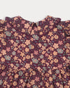 Early Sunday, Marguerite Dress in Garden Flowers Plum, made from Printed Cotton Satin fabric, featuring floral print and detailed lace yoke with Peter Pan collar, shown in a closeup flat-lay view