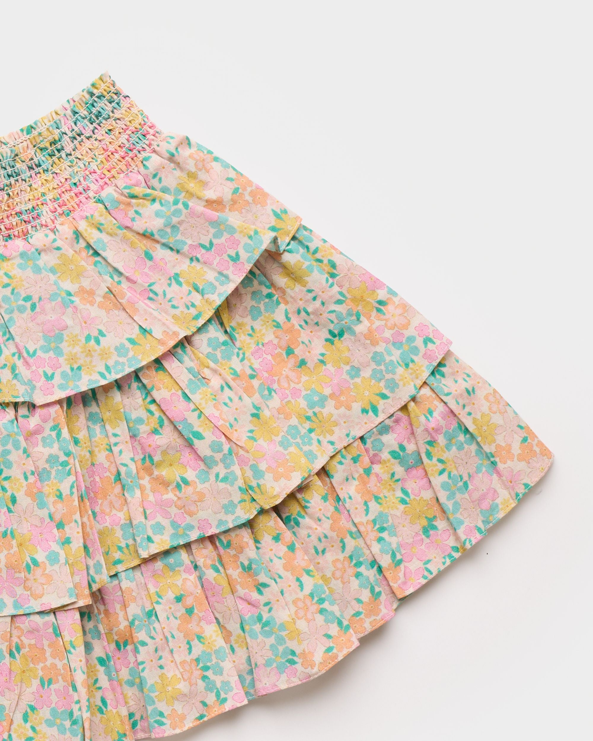 Early Sunday, Melissa Skirt in Emma Floral Mint color, made from Organic Printed Cotton Cambric fabric, featuring tiered frilly skirt with smocked waistband, shown in a closeup flat-lay view