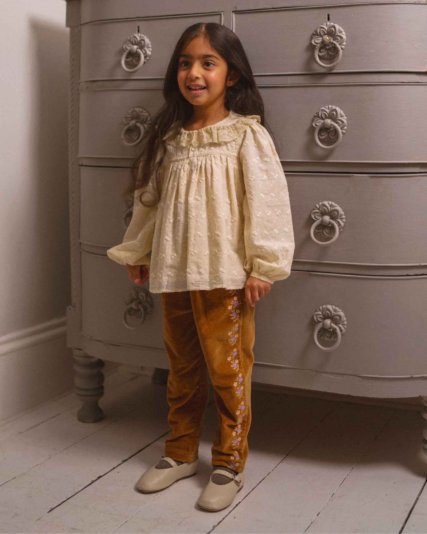 Early Sunday, Adrien Trouser in Almond, made from Dyed Cotton Velvet fabric, featuring Relaxed design with ample room for movement, perfect for active kids, shown in a front view of model wearing it