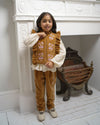 Early Sunday, Adrien Trouser in Almond, made from Dyed Cotton Velvet fabric, featuring Relaxed design with ample room for movement, perfect for active kids, shown in a front view of a model wearing it in a studio setting