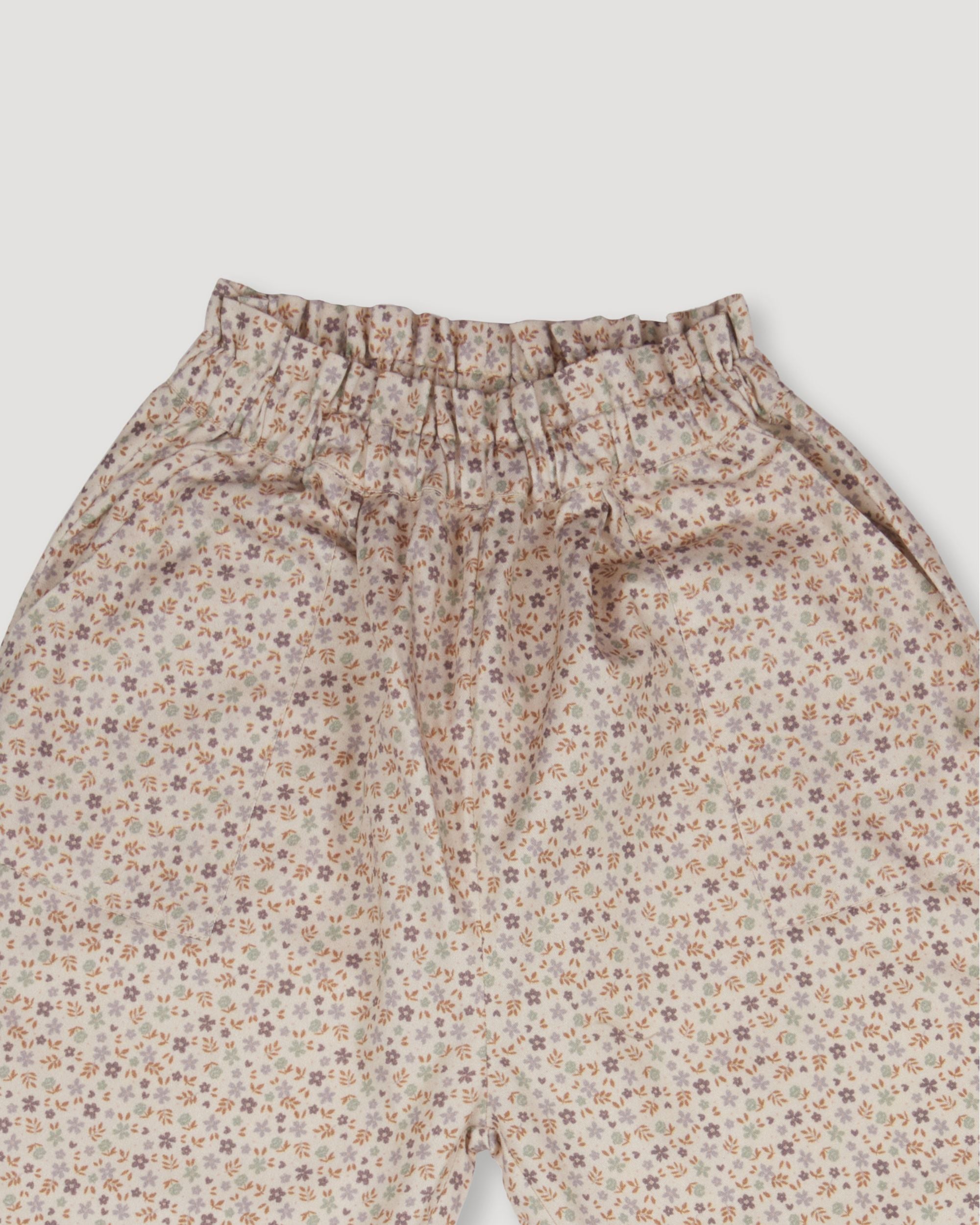 Early Sunday, Adrien Trouser in Miny Flowers print, made from Printed 30s Cotton Twill fabric, featuring Relaxed design with ample room for movement, perfect for active kids, shown in a closeup flat-lay view