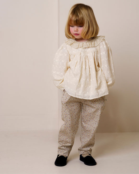Early Sunday, Adrien Trouser in Miny Flowers print, made from Printed 30s Cotton Twill fabric, featuring Relaxed design with ample room for movement, perfect for active kids, shown in a front view of model wearing it