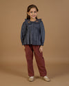 Early Sunday, Adrin Trouser in Caramel, made from Cotton Corduroy fabric, featuring a relaxed silhouette with a comfortable elastic waistband, shown in an angled view of a model wearing it in a studio setting