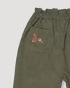 Early Sunday, Adrin Trouser in Moss, made from Cotton Corduroy fabric, featuring a relaxed silhouette with a comfortable elastic waistband, shown in a closeup flat-lay view