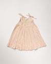 Early Sunday, Alena dress in Pink Stripes color, made from printed 70% cotton 30% linen fabric, featuring tie-up shoulder straps, gathered flare, and ruffled hem, shown in a back flat-lay view.