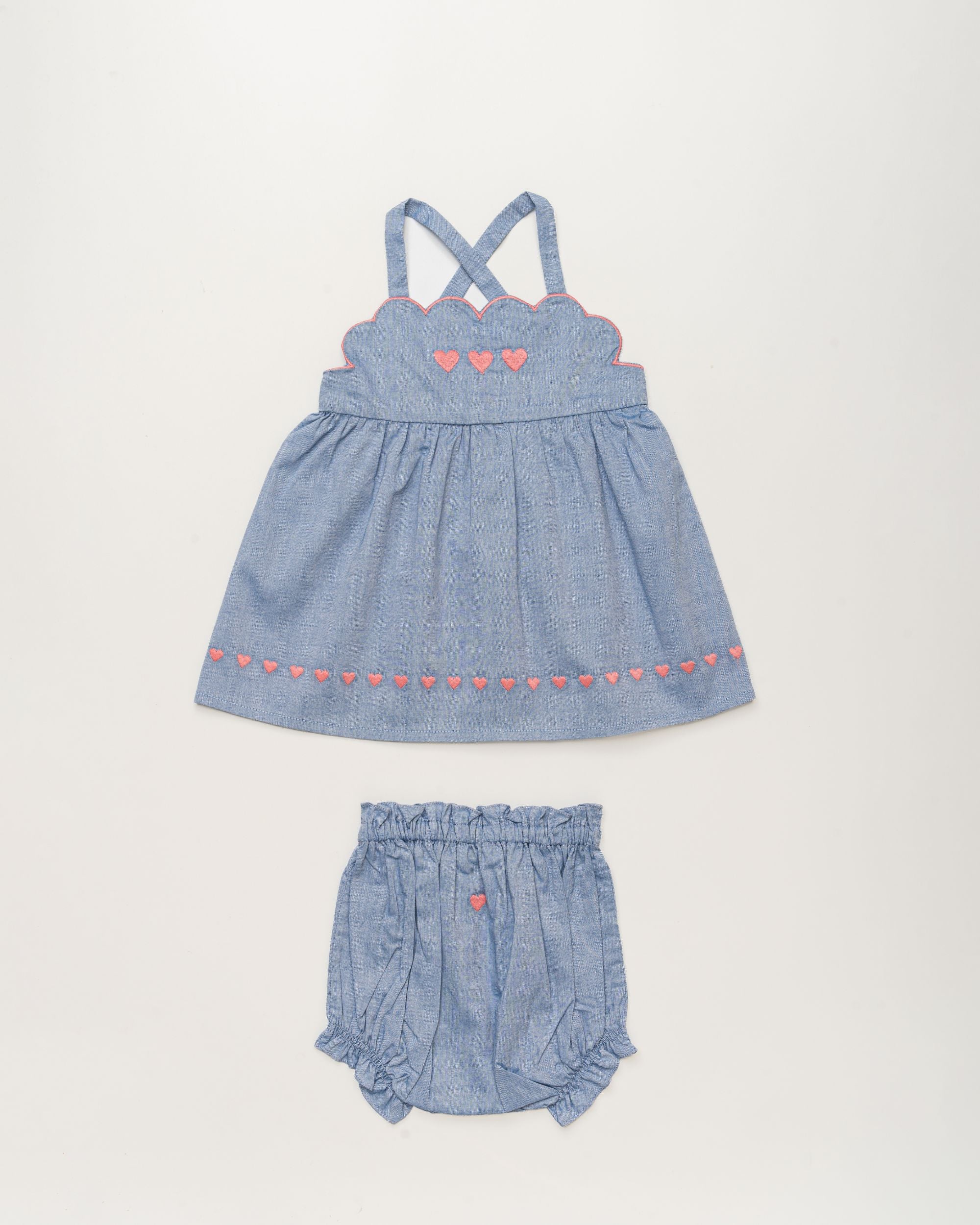 Early Sunday, Alice Baby Dress & Bloomer Set in Summer Sky color, made from 100% Cotton Chambray fabric, featuring a sleeveless design with a smocked bodice & matching bloomers, shown in a front flat-lay view