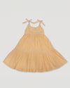 Early Sunday, Alice Dress in Vanilla color, made from Cotton Dobby Swiss Dots fabric, featuring sleeveless with adjustable tie-up straps and a tiered silhouette, shown in a front flat-lay view