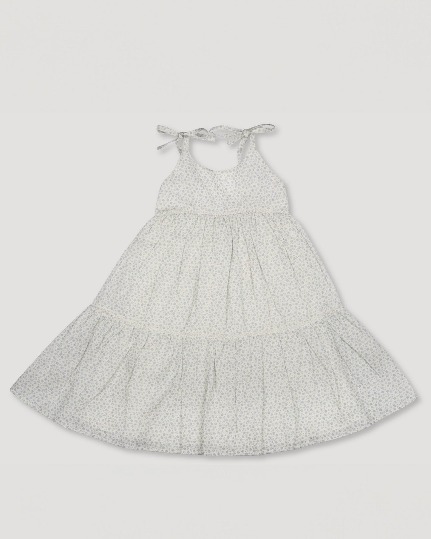 Early Sunday, Alice Dress in Mini Flower print, made from Printed canvas 70% Cotton 30% Linen fabric, featuring sleeveless with adjustable tie-up straps and a tiered silhouette, shown in a front flat-lay view