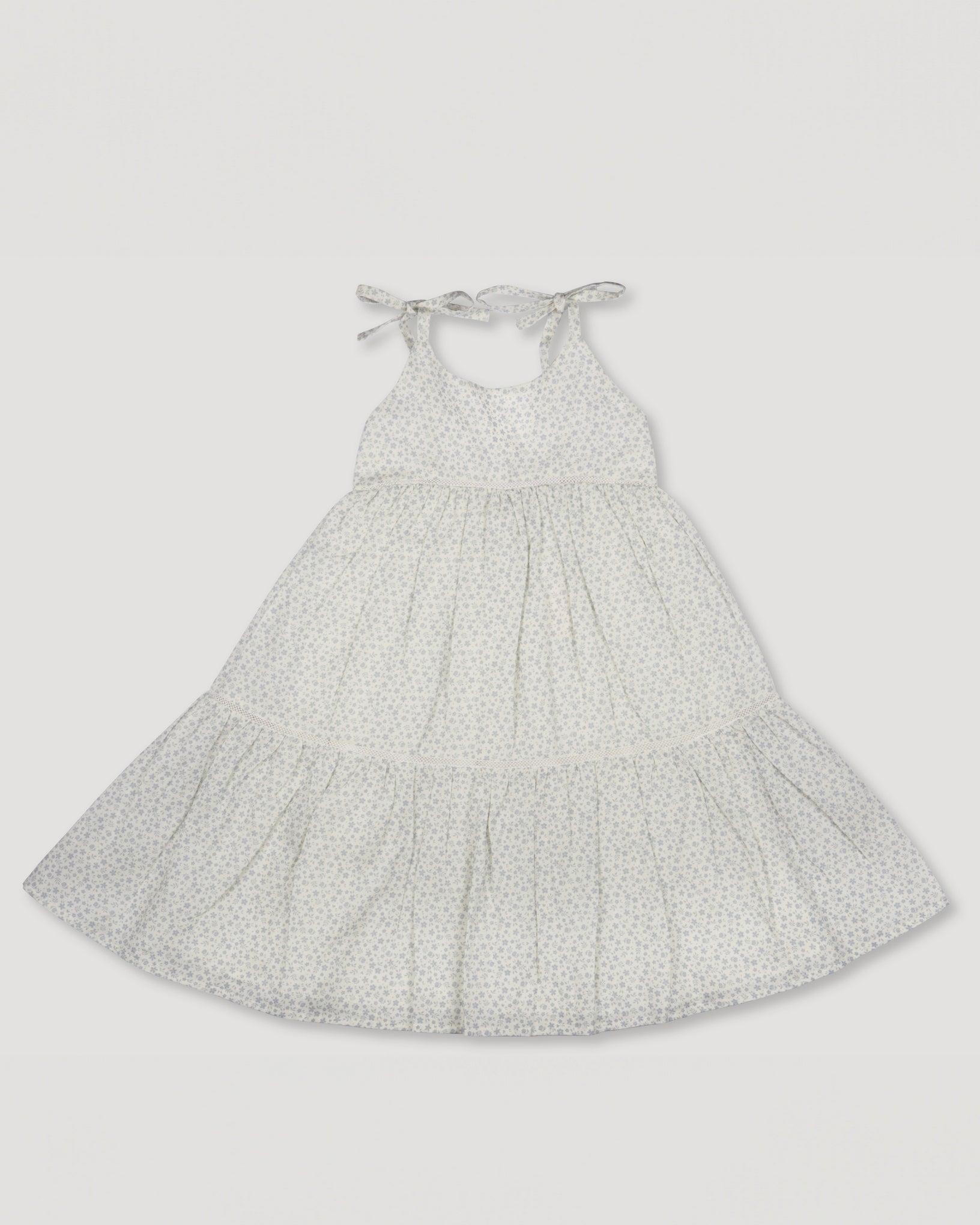 Early Sunday, Alice Dress in Mini Flower print, made from Printed canvas 70% Cotton 30% Linen fabric, featuring sleeveless with adjustable tie-up straps and a tiered silhouette, shown in a front flat-lay view