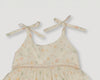 Early Sunday, Alice Dress in Star Fish print, made from Printed Cotton Cambric fabric, featuring sleeveless with adjustable tie-up straps and a tiered silhouette, shown in a closeup flat-lay view