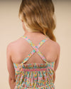 Early Sunday, Alisson Dress in Emma Floral Mint color, made from organic printed cotton cambric fabric, featuring smocked bodice, adjustable shoulder straps, sweet tassel accents, and a flowy gathered skirt, shown in a back view of model wearing.