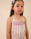 Early Sunday, Alisson Dress in butterfly print color, made from printed cotton tiny swiss dobby fabric, featuring smocked bodice, adjustable shoulder straps, sweet tassel accents, and a flowy gathered skirt, shown in a front view of model wearing.