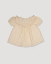 Early Sunday, Amelia Blouse in Hazelnut Cream, made from Dyed Cotton Swiss Dobby Tiny Dots fabric, featuring Classic pleats that enhance the fit and finish, shown in a back flat-lay view