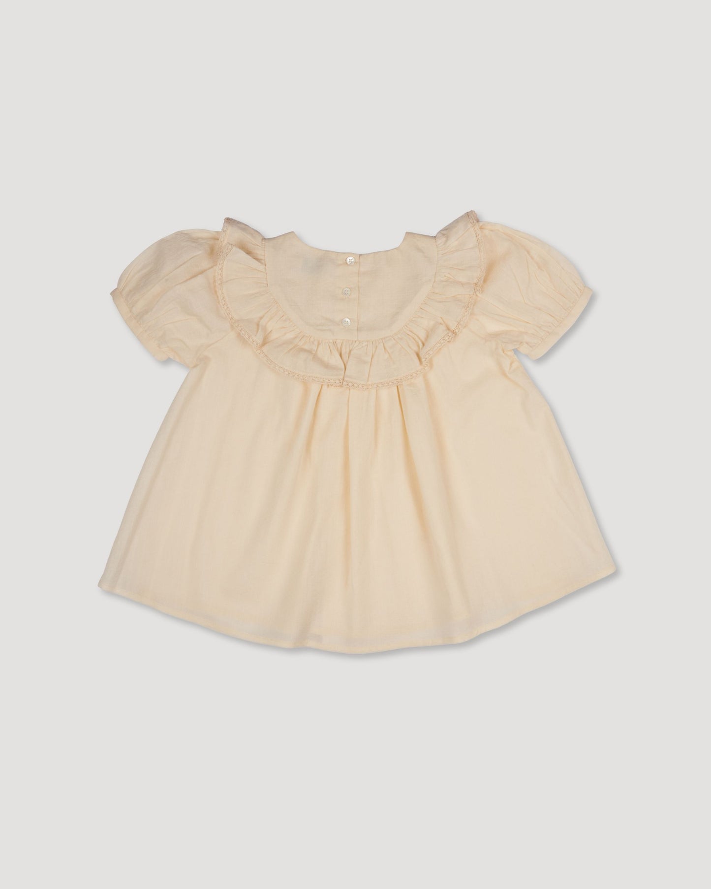 Early Sunday, Amelia Blouse in Hazelnut Cream, made from Dyed Cotton Swiss Dobby Tiny Dots fabric, featuring Classic pleats that enhance the fit and finish, shown in a back flat-lay view