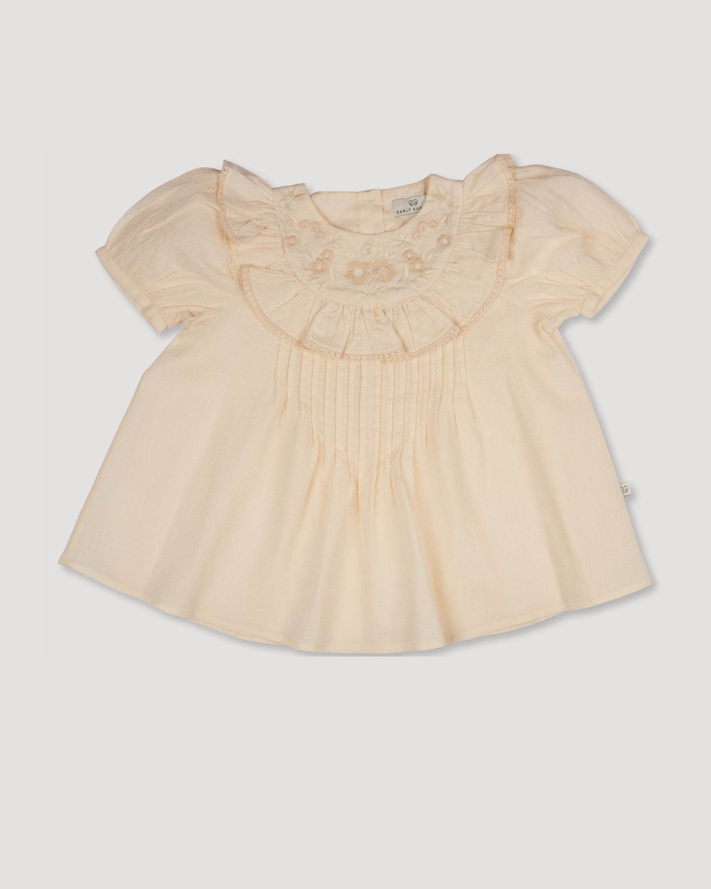 Early Sunday, Amelia Blouse in Hazelnut Cream, made from Dyed Cotton Swiss Dobby Tiny Dots fabric, featuring Classic pleats that enhance the fit and finish, shown in a front flat-lay view