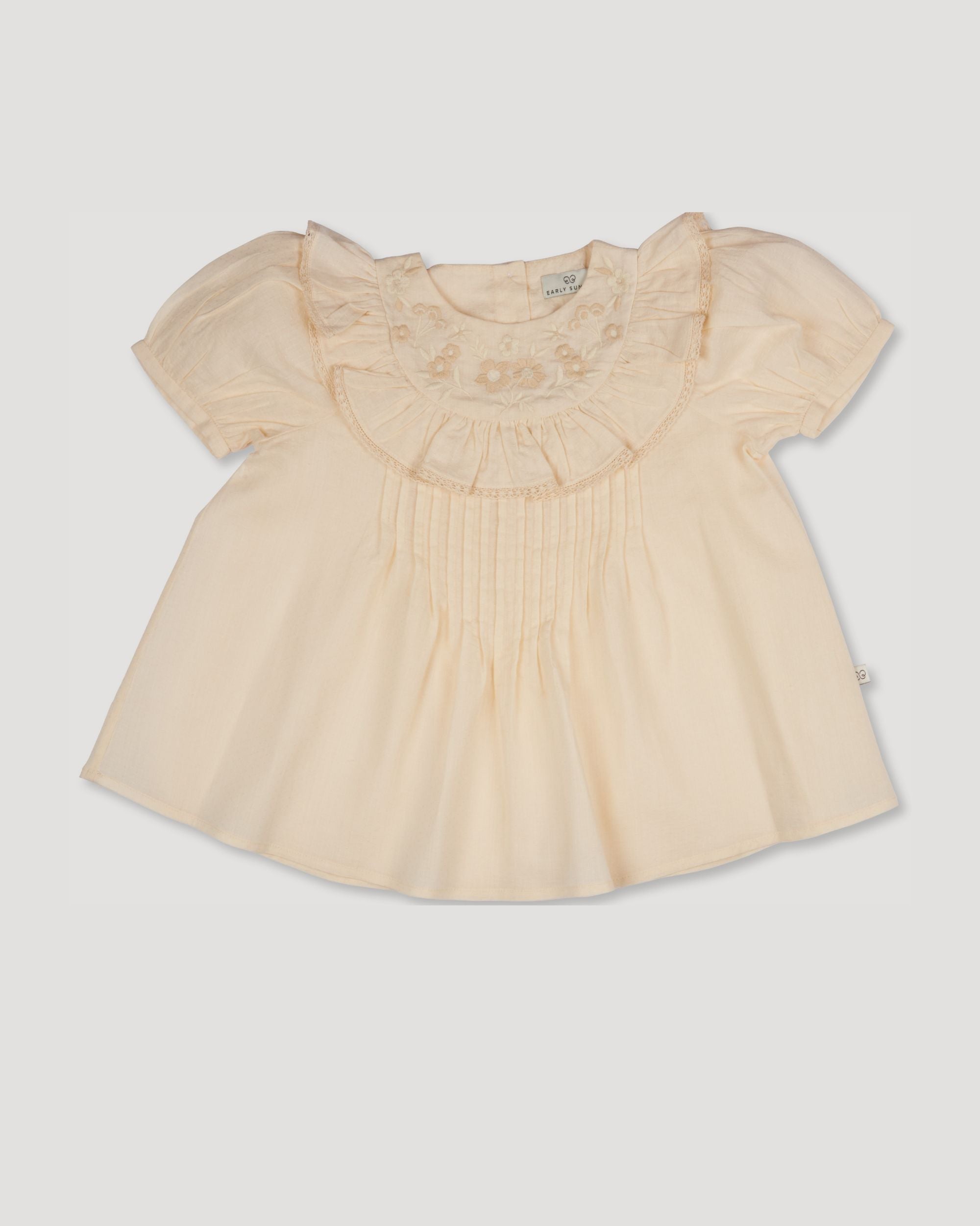 Early Sunday, Amelia Blouse in Hazelnut Cream, made from Dyed Cotton Swiss Dobby Tiny Dots fabric, featuring Classic pleats that enhance the fit and finish, shown in a front flat-lay view