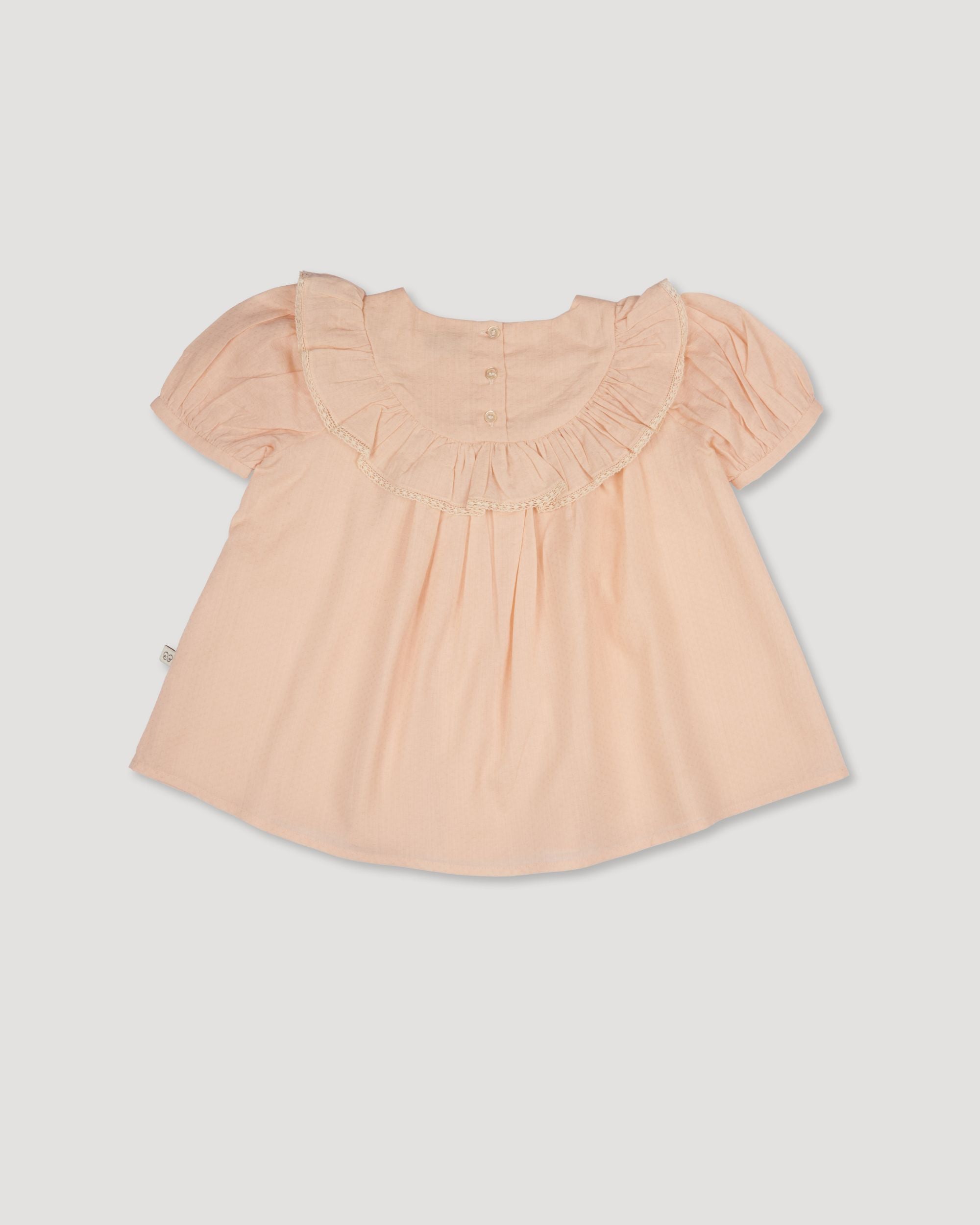 Early Sunday, Amelia Blouse in Nude, made from Dyed Cotton Swiss Dobby Tiny Dots fabric, featuring Classic pleats that enhance the fit and finish, shown in a back flat-lay view