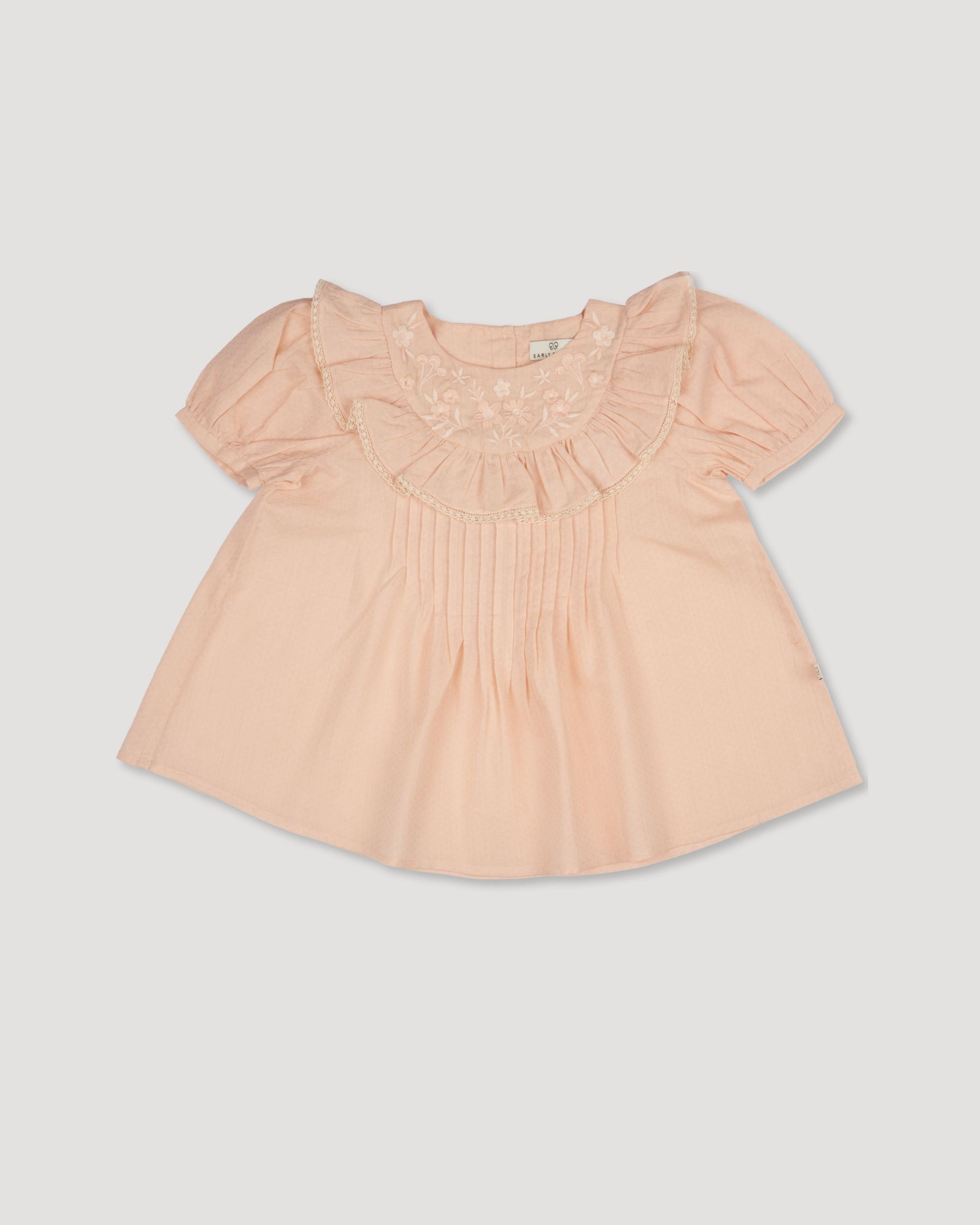 Early Sunday, Amelia Blouse in Nude, made from Dyed Cotton Swiss Dobby Tiny Dots fabric, featuring Classic pleats that enhance the fit and finish, shown in a front flat-lay view