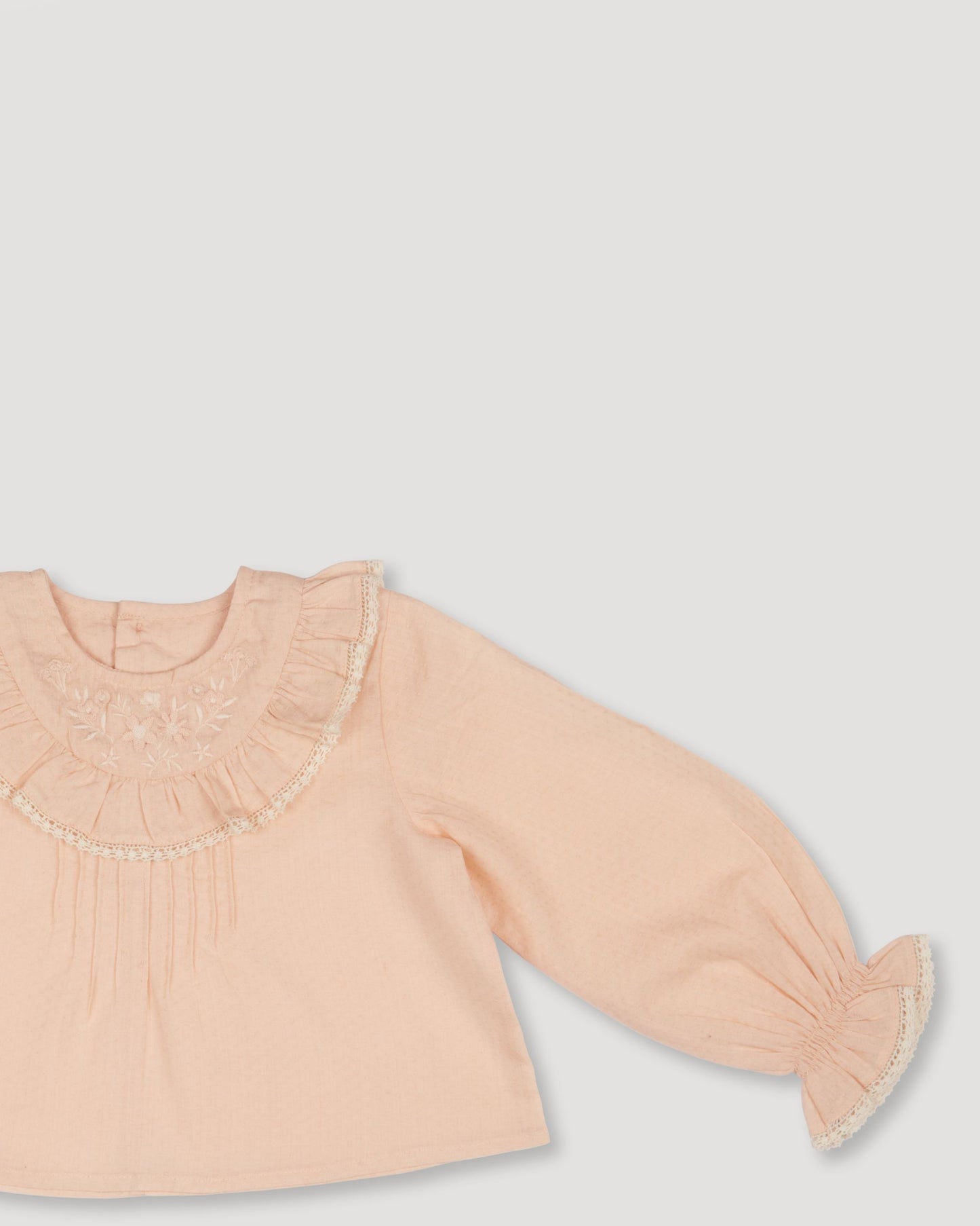 Early Sunday, Amy Baby Blouse & Bloomer Set in Nude & Celestial print, made from Dyed Cotton Swiss Dobby Tiny Dots fabric, featuring a delicate embroidery & lace-trimmed ruffles with elasticated bloomers, shown in a closeup flat-lay view