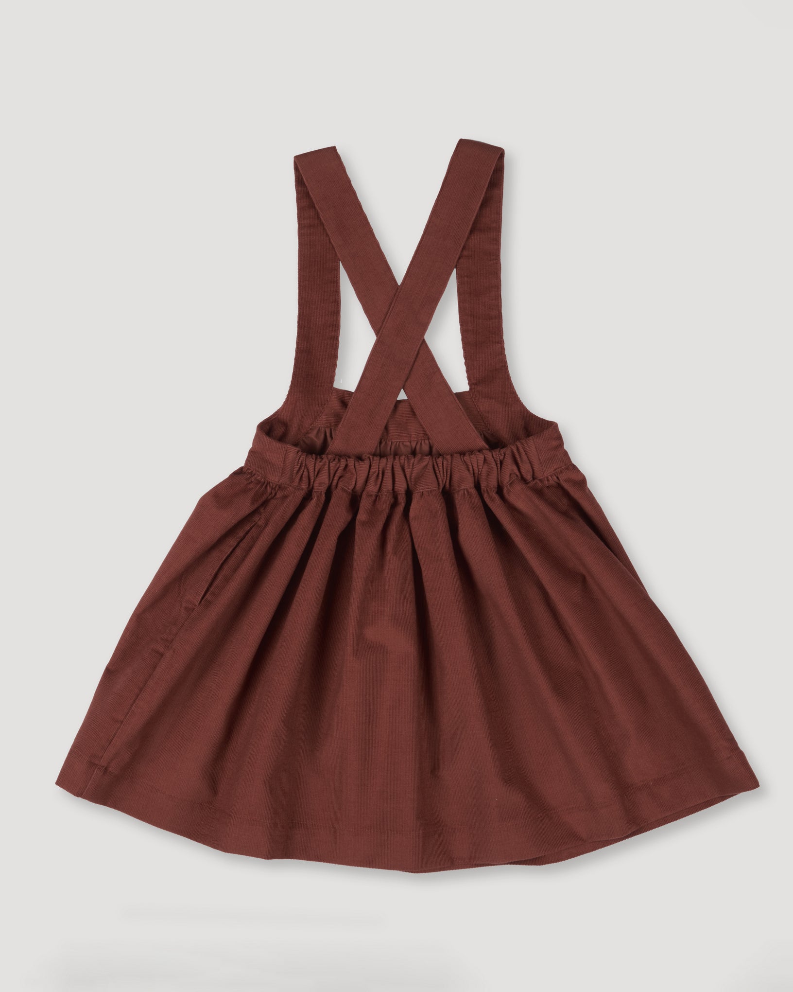 Early Sunday, Annie Skirt in Caramel color, made from Cotton Corduroy fabric, featuring a relaxed fit with an elastic waistband & beautiful embroidery, shown in a back flat-lay view