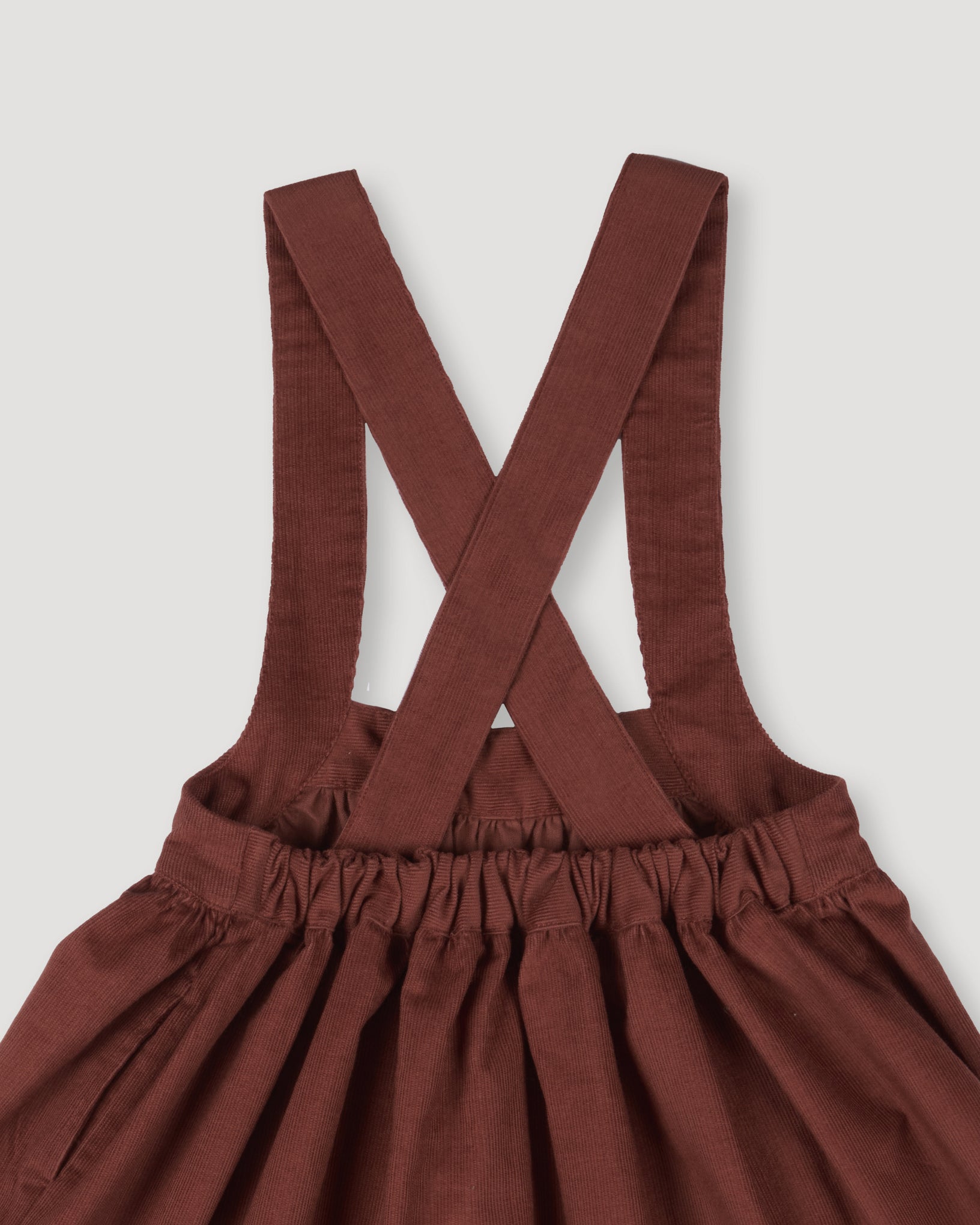 Early Sunday, Annie Skirt in Caramel color, made from Cotton Corduroy fabric, featuring a relaxed fit with an elastic waistband & beautiful embroidery, shown in a closeup flat-lay view
